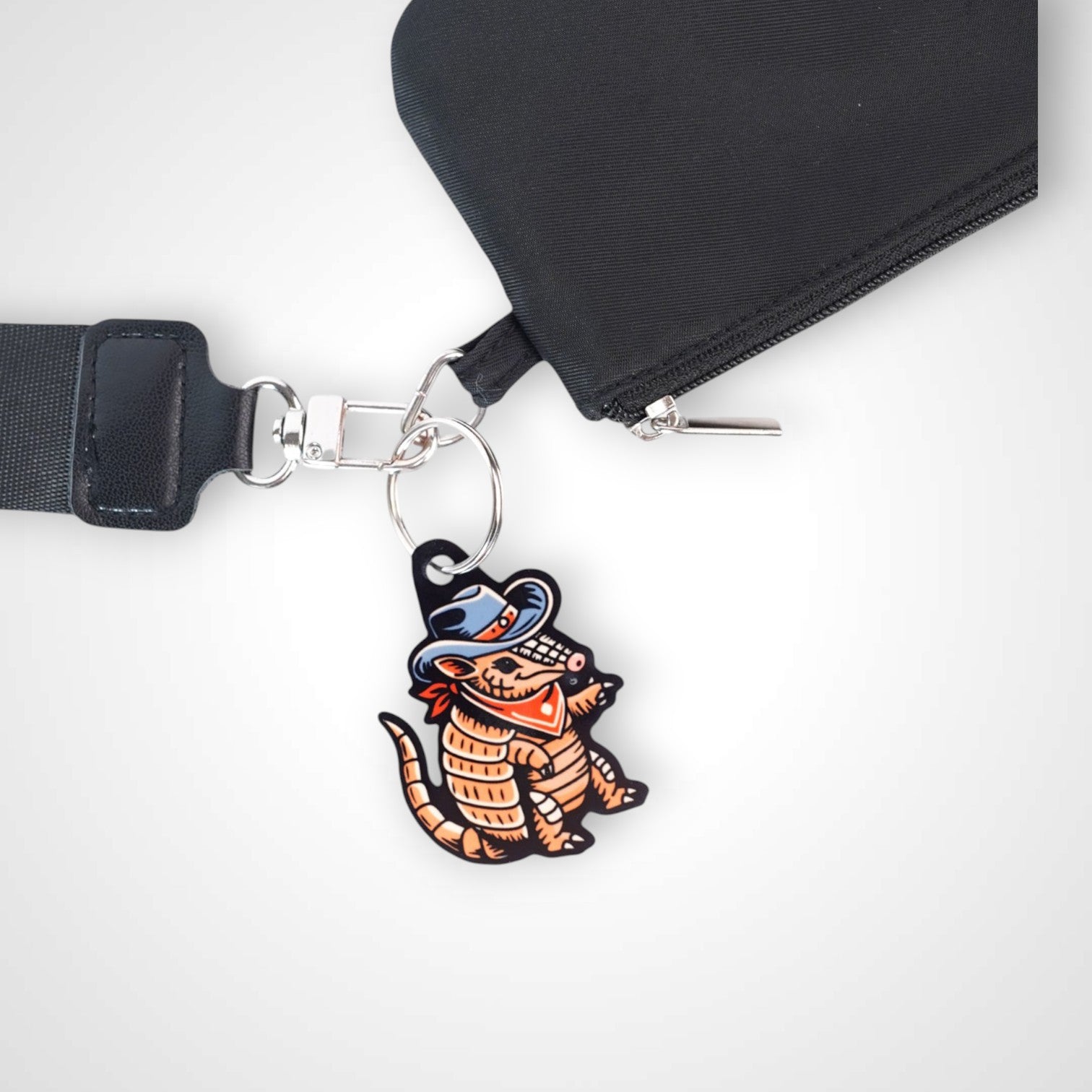 Cowboy armadillo cast acrylic keychain with double coil keyring. Shown on wallet.