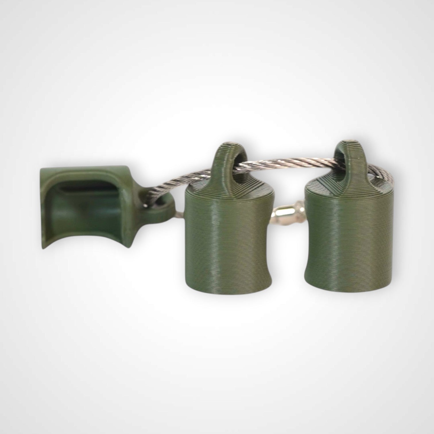 Three army green polylactic acid created using additive manufacturing classic cap clips on steel cable keyring. Shown on a white background.