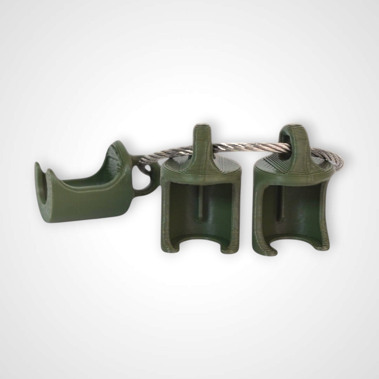 Three army green polylactic acid created using additive manufacturing classic cap clips on steel cable keyring. Shown on a white background.