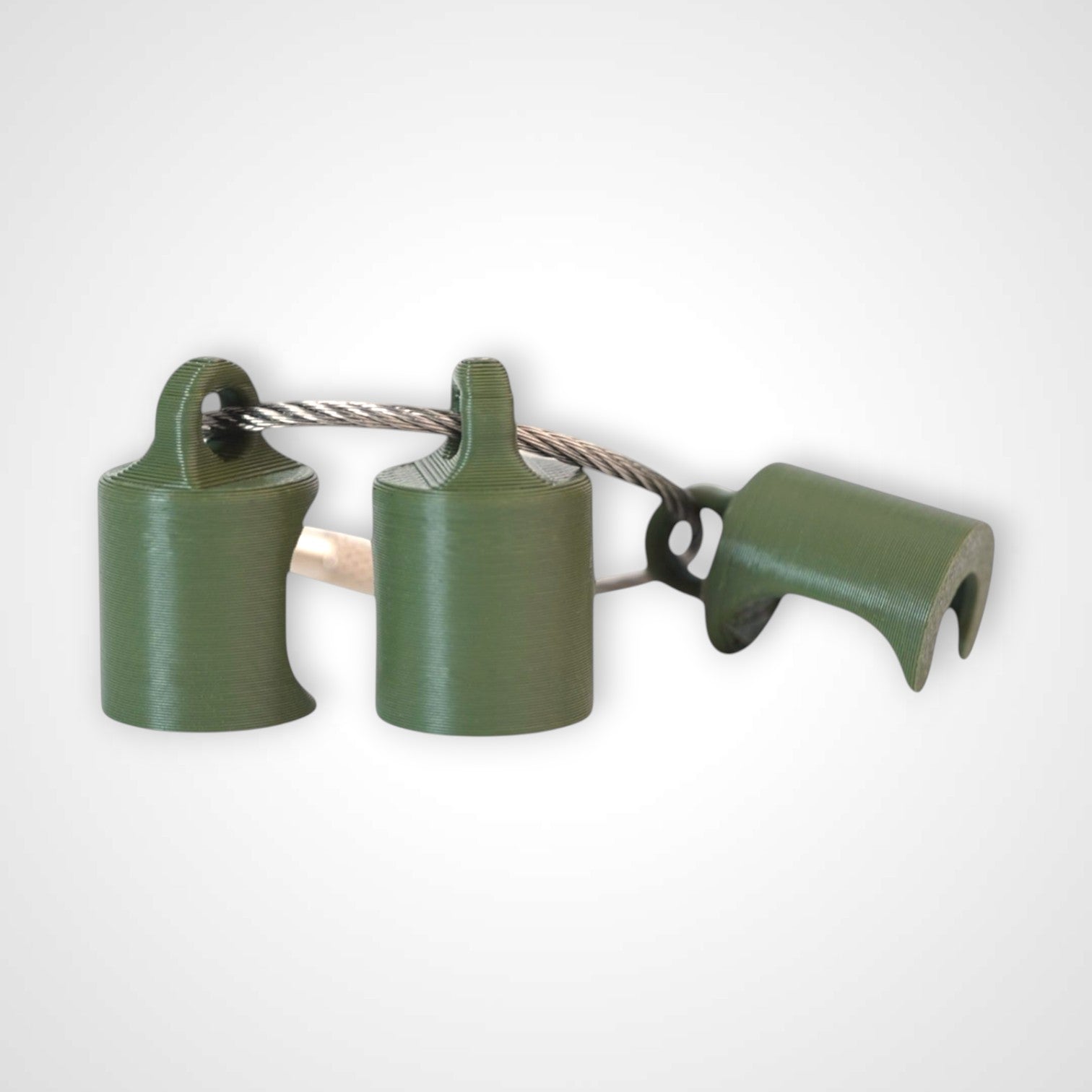 Three army green polylactic acid created using additive manufacturing classic cap clips on steel cable keyring. Shown on a white background.