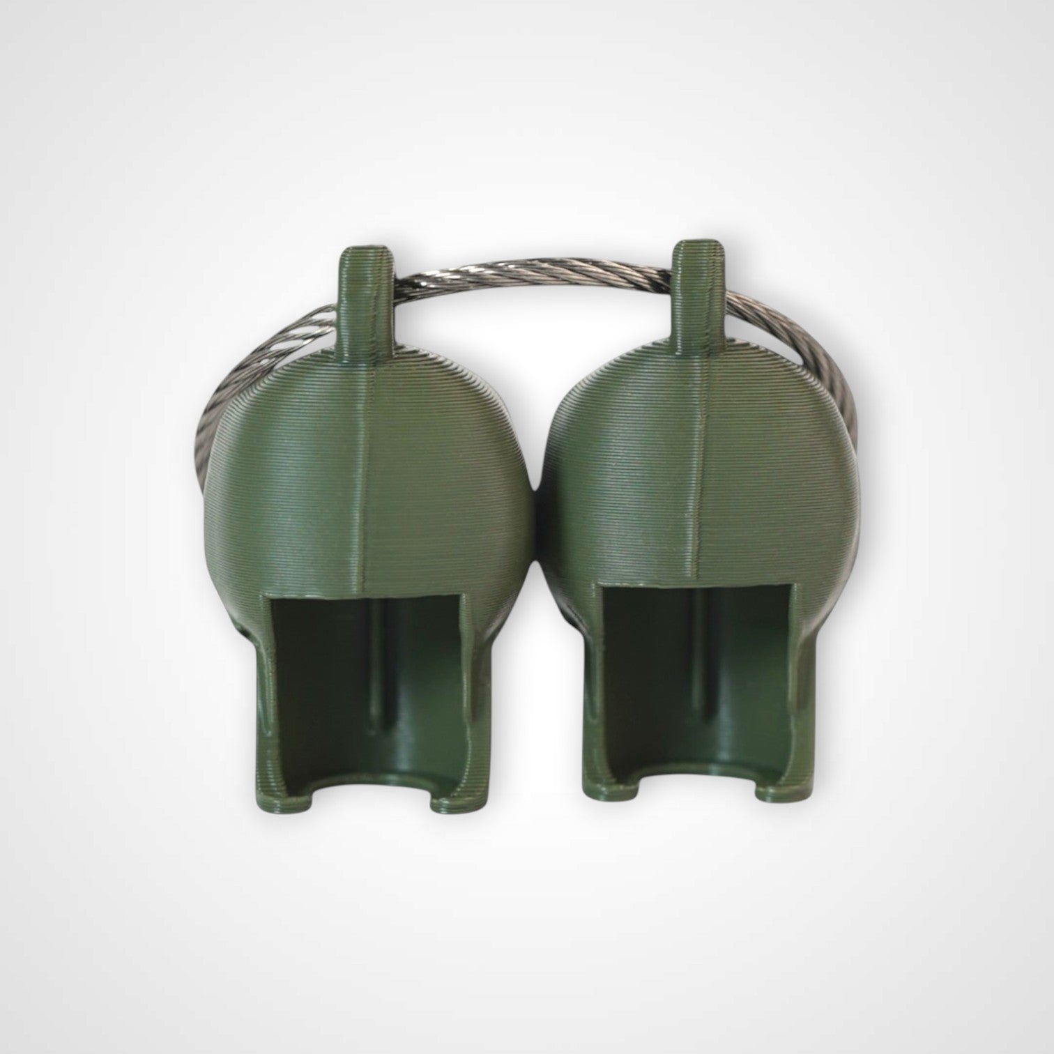 Two army green polylactic acid created using additive manufacturing skull cap clips on steel cable keyring. Shown on a white background.