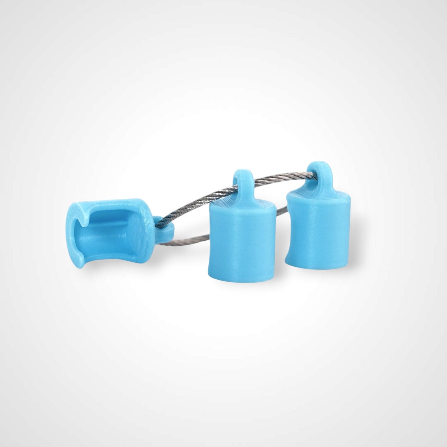 Three blue polylactic acid created using additive manufacturing classic cap clips on steel cable keyring. Shown on a white background.