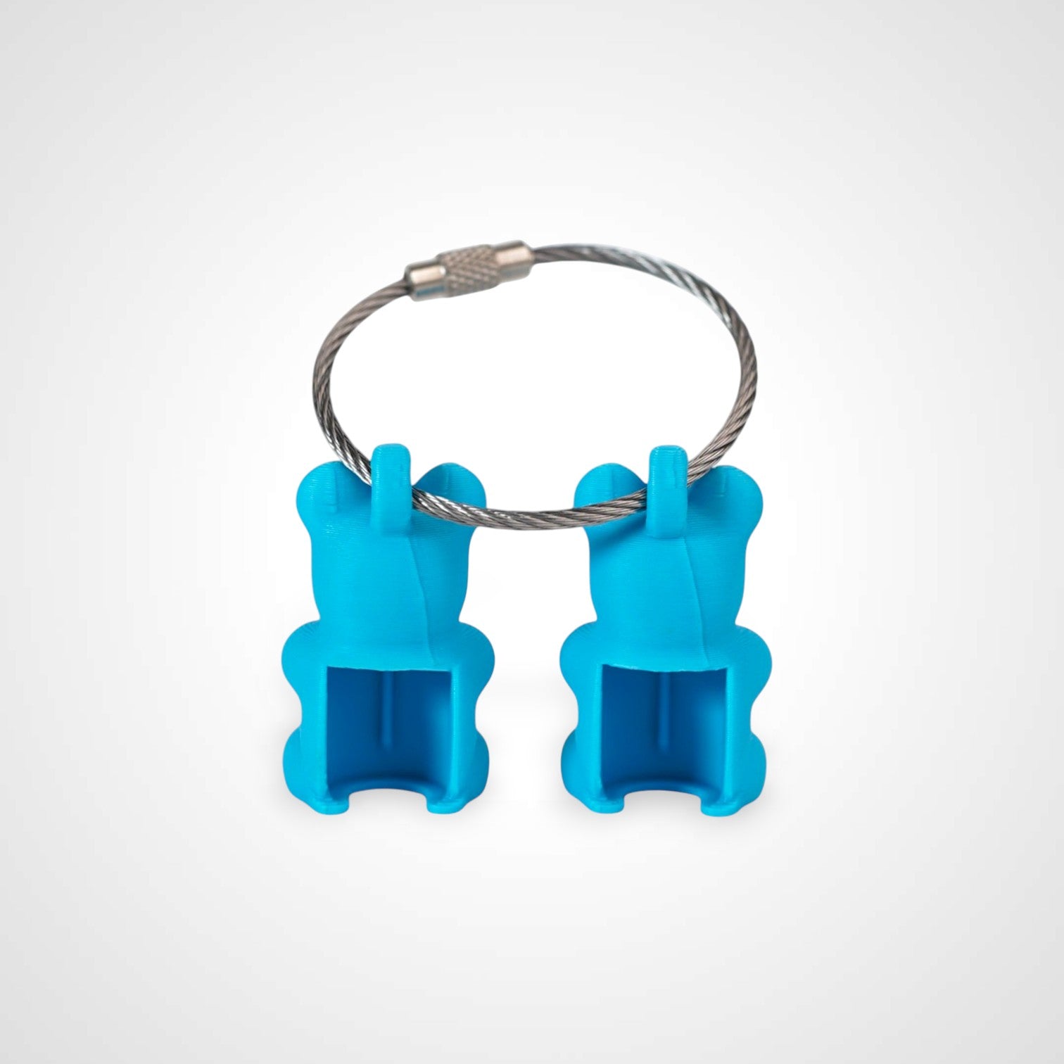 Two blue polylactic acid created using additive manufacturing gummy bear clips on steel cable keyring. Shown on a white background.