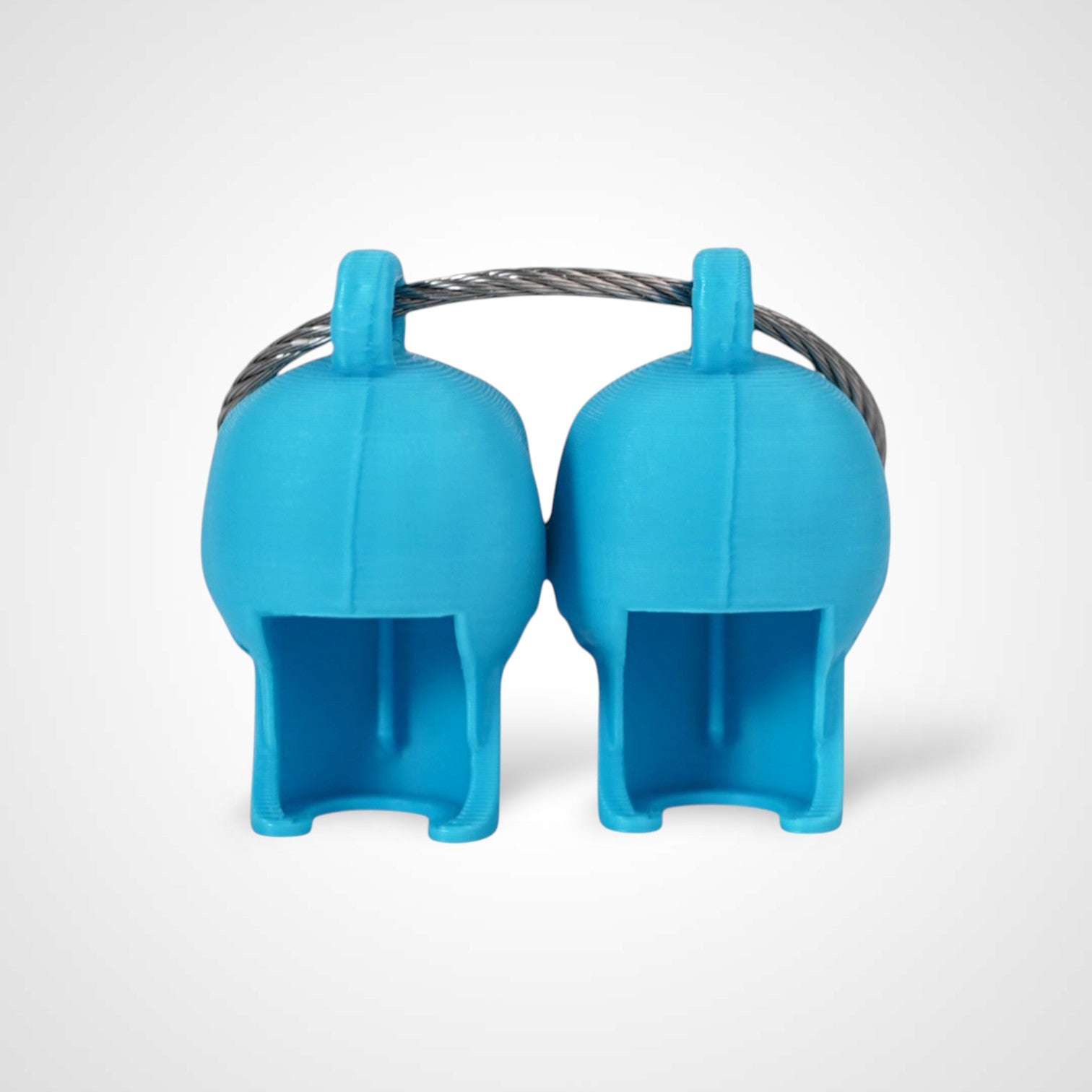 Two blue polylactic acid created using additive manufacturing skull cap clips on steel cable keyring. Shown on a white background.