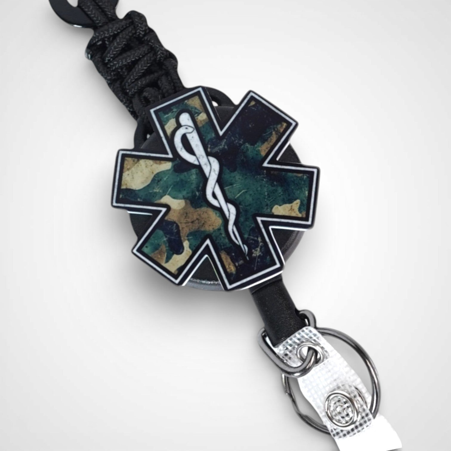Camo Star badge reel. On a carabiner with a steel retractable cable. Shown on a white background.