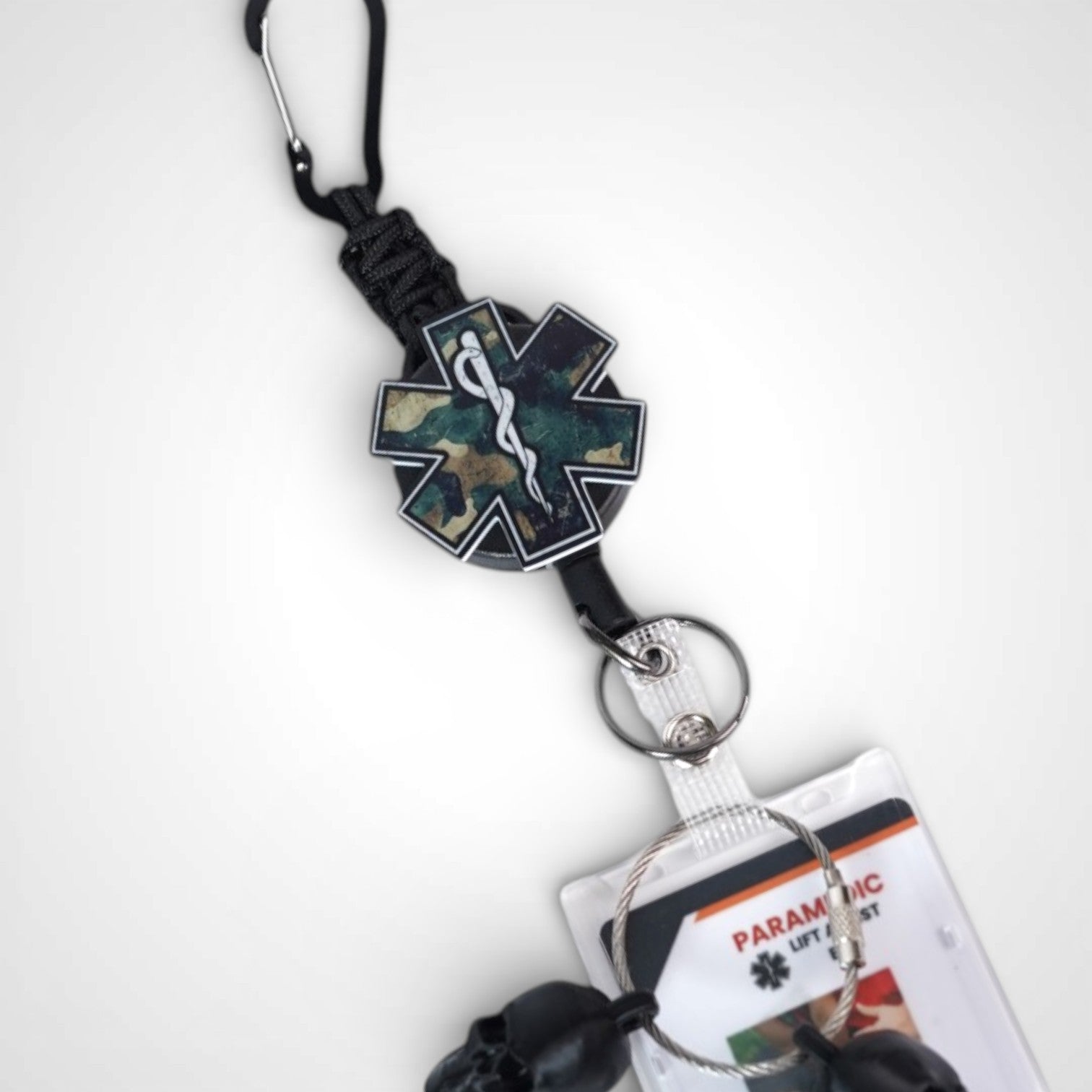 Camo Star badge reel. On a carabiner with a steel retractable cable. Shown on a white background.
