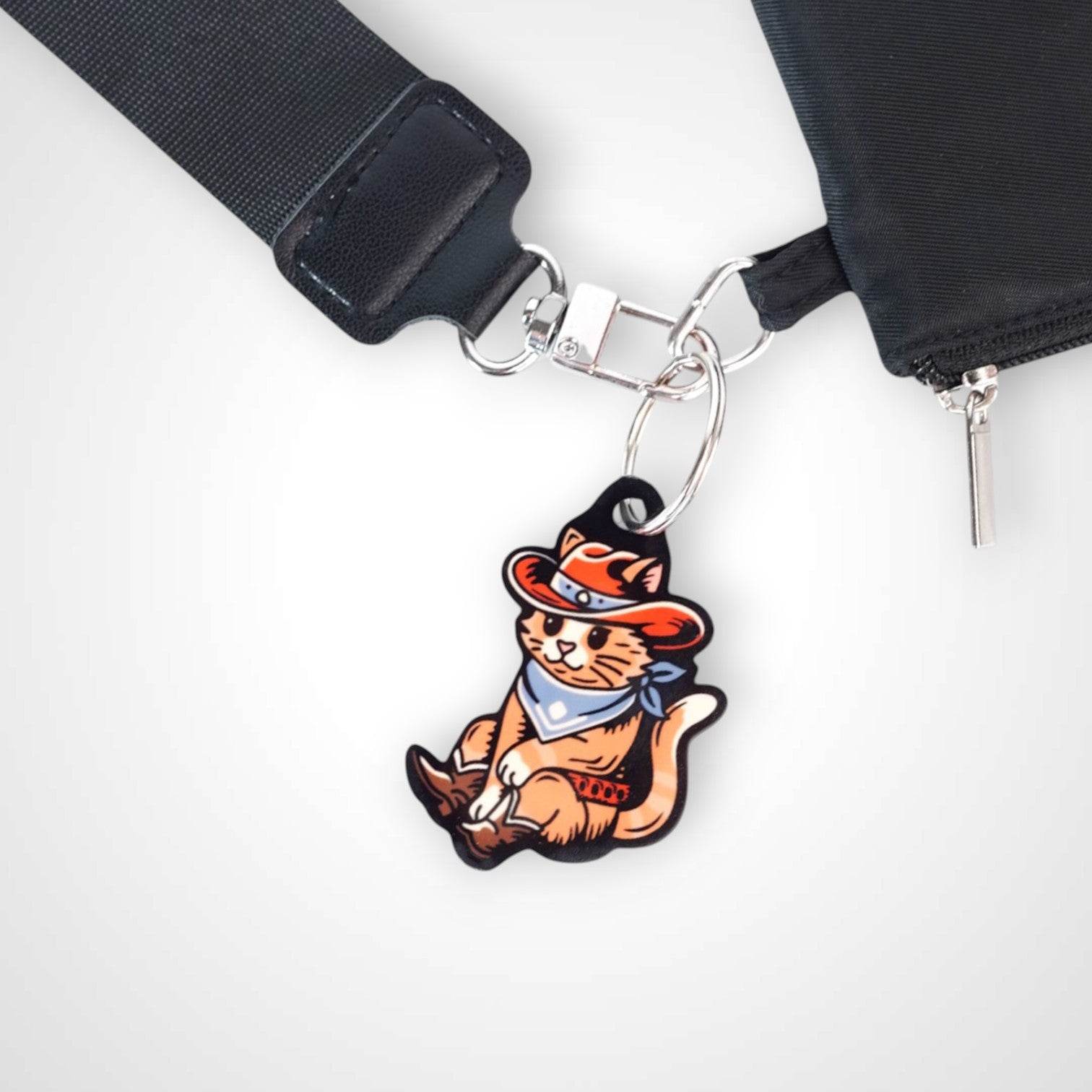 Cowboy cat cast acrylic keychain with double coil keyring. Shown on wallet.