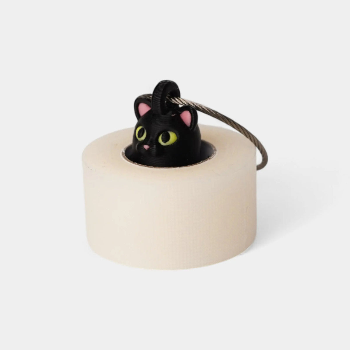 Halloween Cat Black 1-inch roll holder made with polylactic acid, created using additive manufacturing for holding tape and bandage rolls. With a steel cable keyring. Shown with tape on white background.