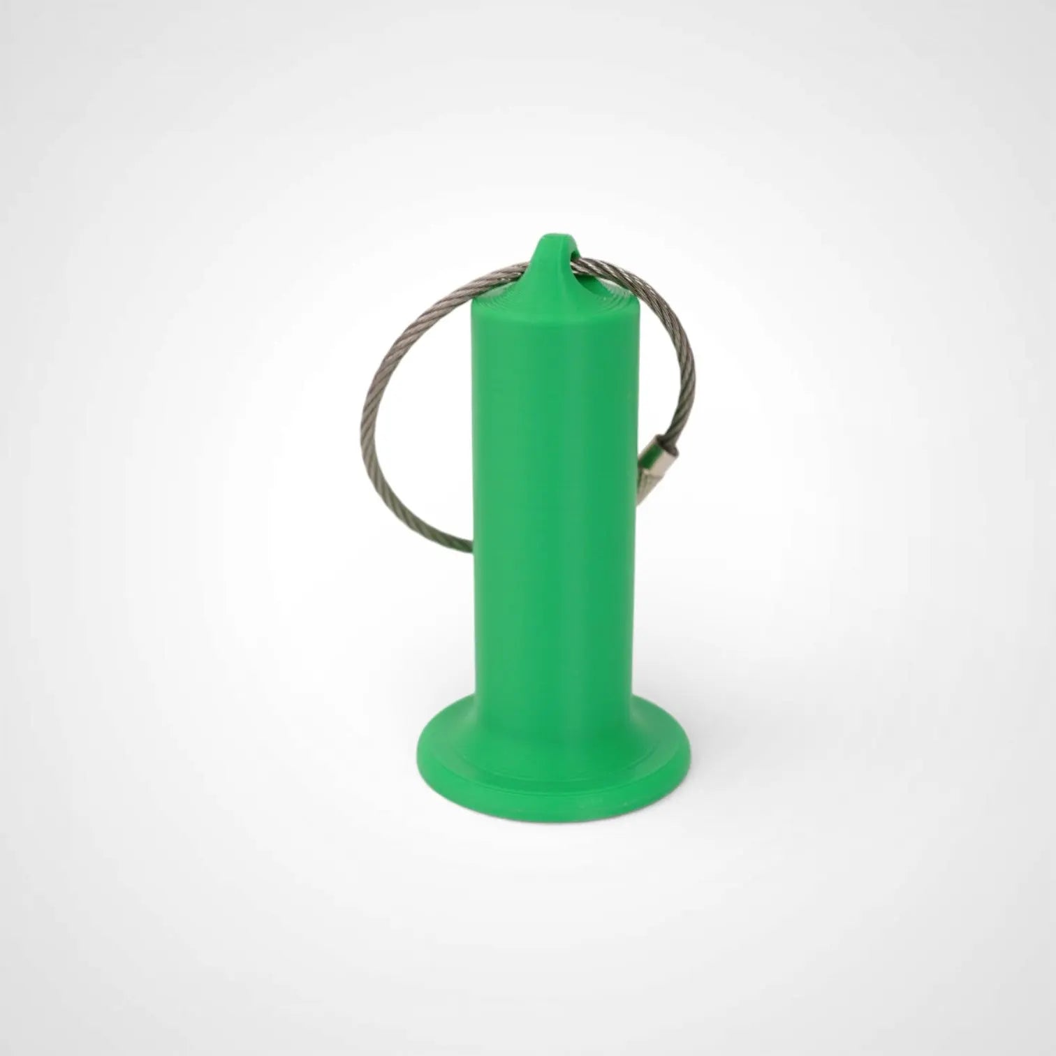 Green 2-inch roll holder made with polylactic acid, created using additive manufacturing for holding tape and bandage rolls. With a steel cable keyring. Shown on white background.