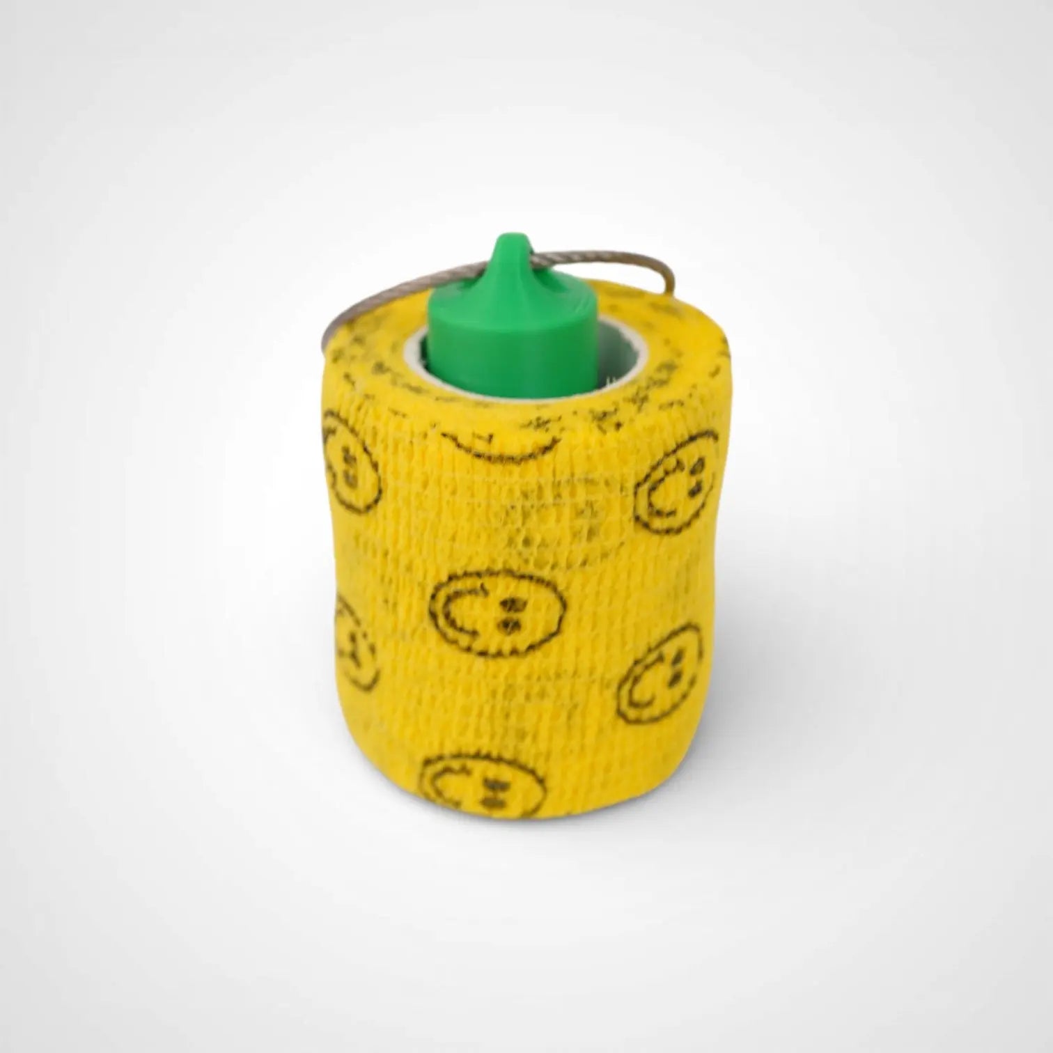 Green 2-inch roll holder made with polylactic acid, created using additive manufacturing for holding tape and bandage rolls. With a steel cable keyring. Shown with tape on white background.