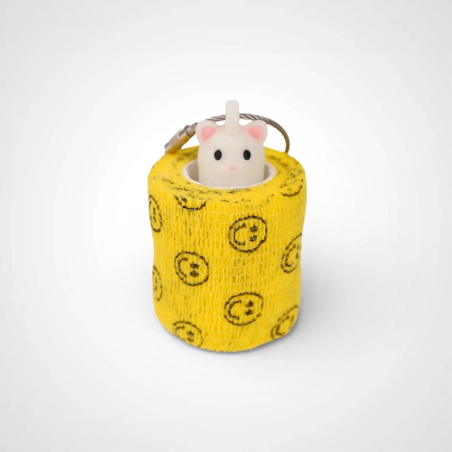 Cat White Glow 2-inch roll holder made with polylactic acid, created using additive manufacturing for holding tape and bandage rolls. With a steel cable keyring. Shown with tape on white background.