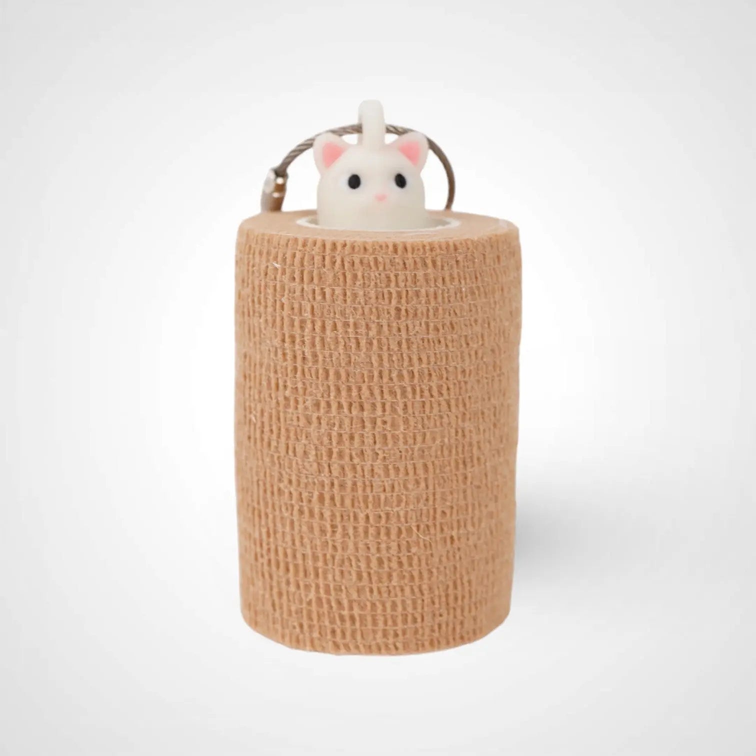Cat White Glow 3-inch roll holder made with polylactic acid, created using additive manufacturing for holding tape and bandage rolls. With a steel cable keyring. Shown with tape on white background.