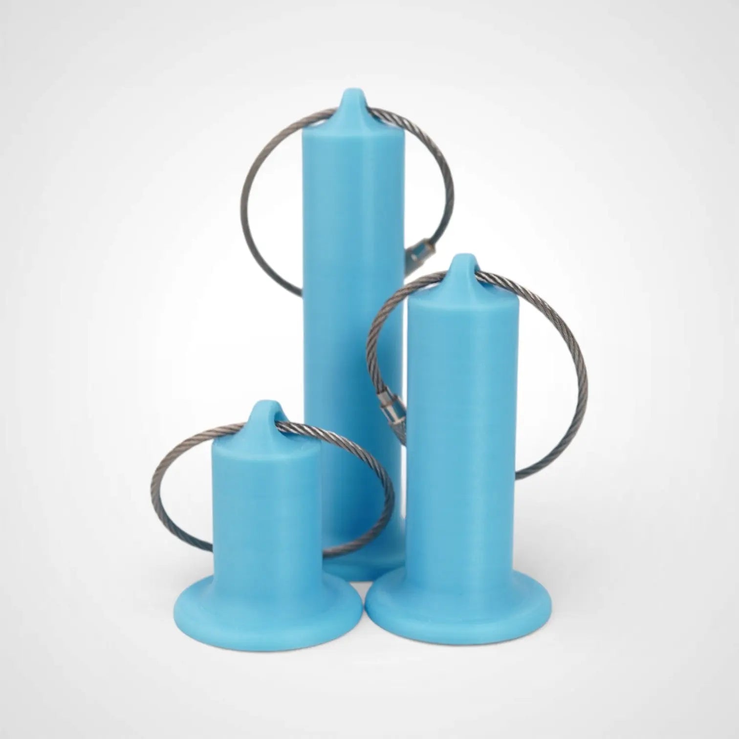 Blue Glow Teal roll holders made with polylactic acid, created using additive manufacturing for holding tape and bandage rolls. In three sizes, 1-inch, 2-inch, and 3-inch. With a steel cable keyring. All three sizes shown on white background.