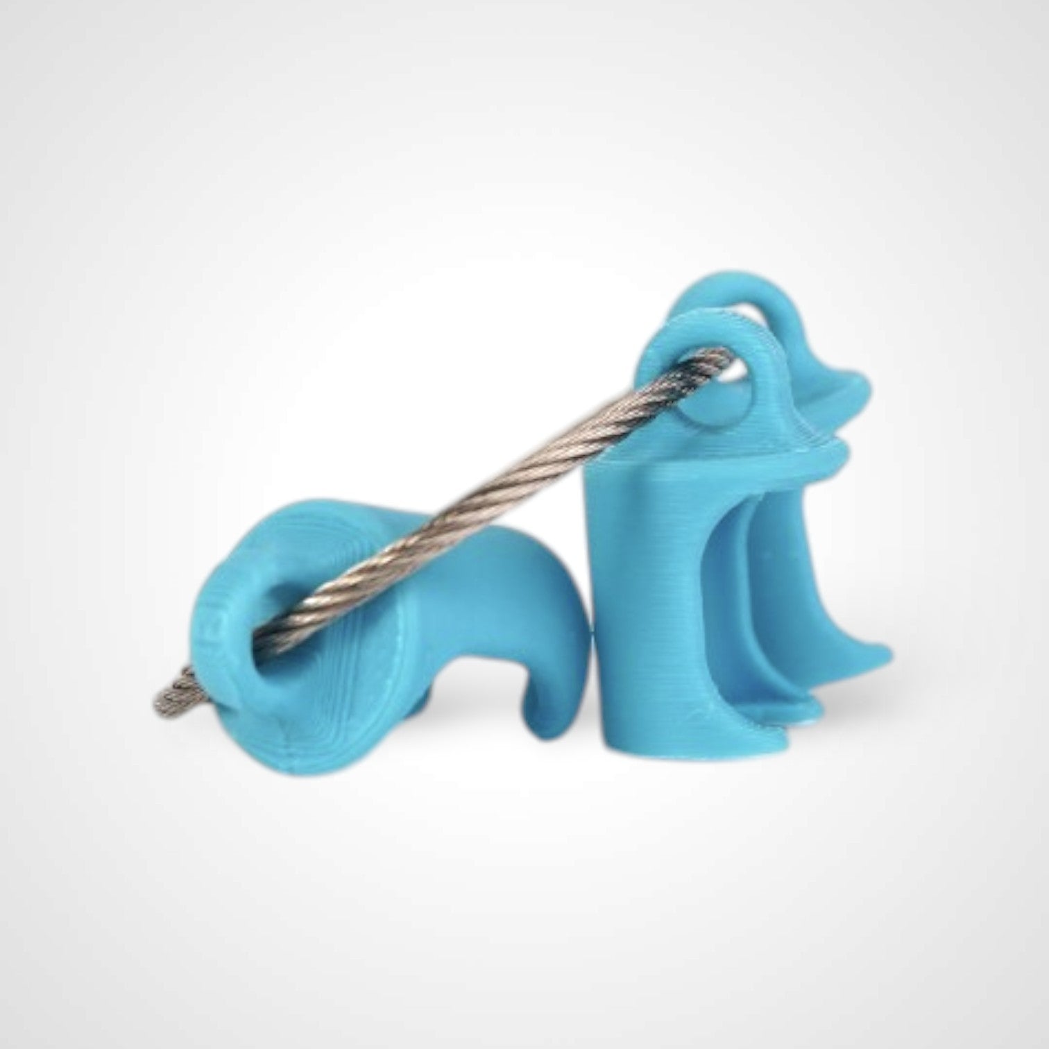 Three blue polylactic acid created using additive manufacturing classic cap clips on steel cable keyring. Shown on a white background.