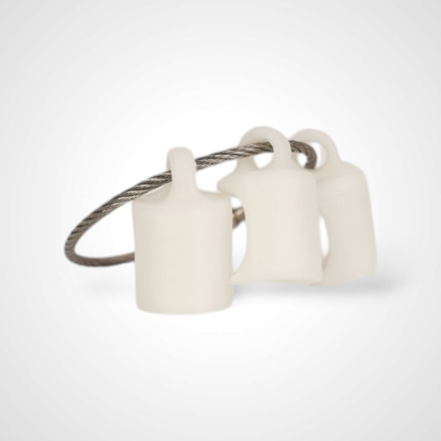 Three white polylactic acid created using additive manufacturing classic cap clips on steel cable keyring. Shown on a white background.