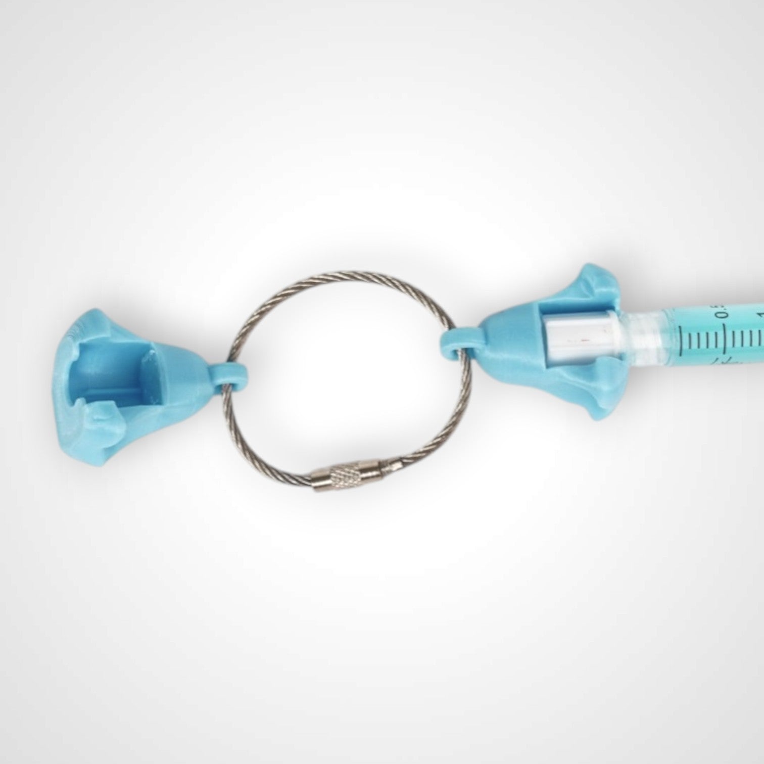 Two blue polylactic acid created using additive manufacturing ghost cap clips on steel cable keyring. Featured attached to a syringe. Shown on a white background.