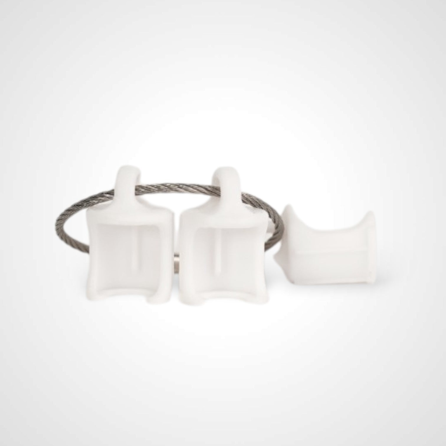 Three white polylactic acid created using additive manufacturing faux flush cap clip on steel cable keyring. Shown on a white background.
