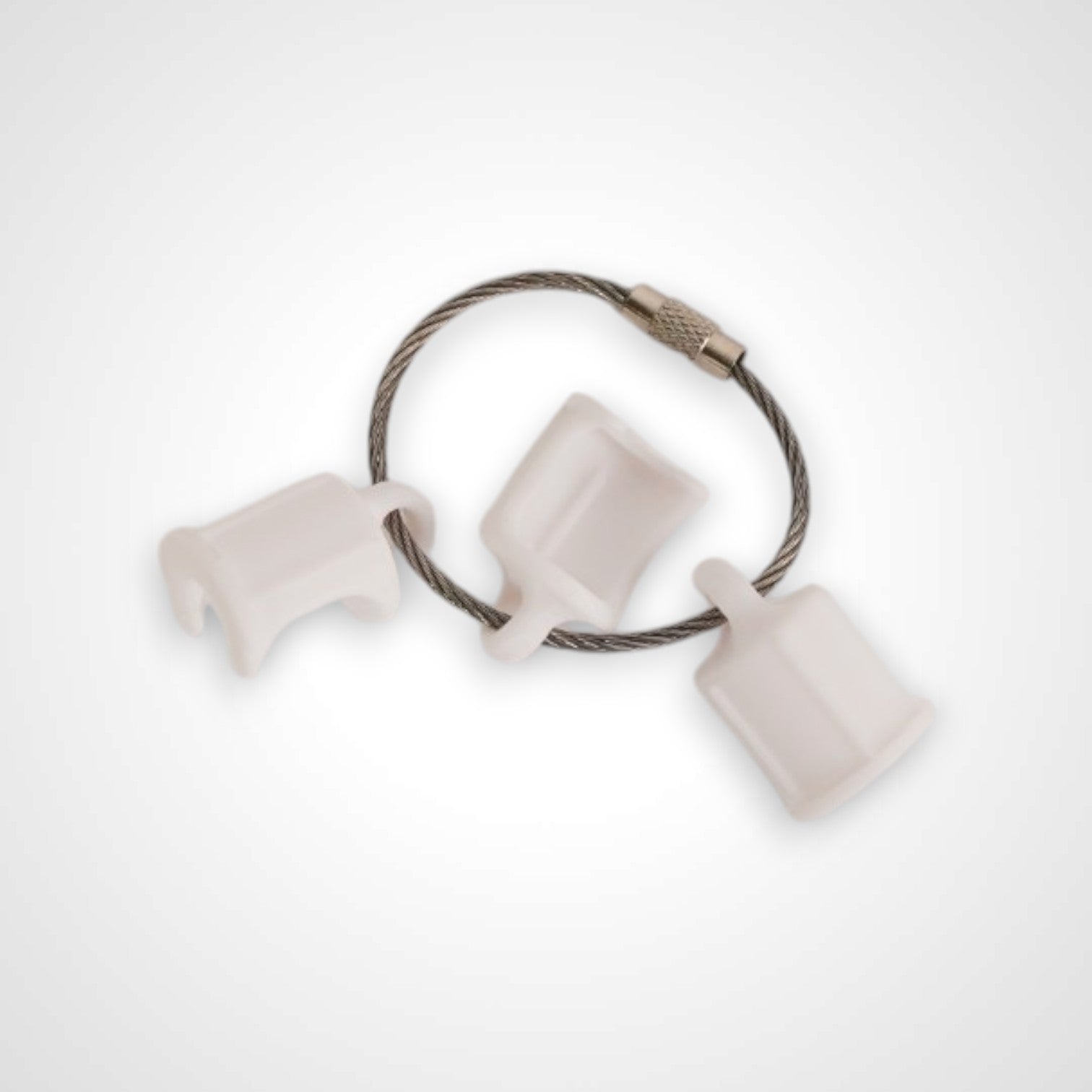 Three white polylactic acid created using additive manufacturing faux flush cap clip on steel cable keyring. Shown on a white background.