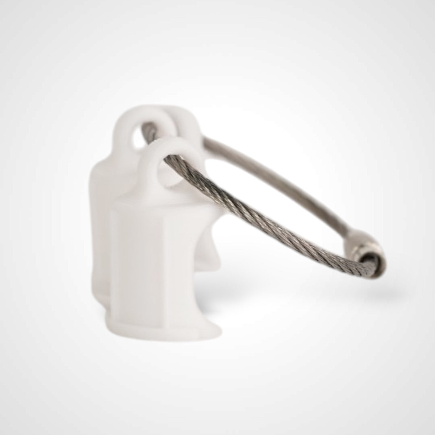 Three white polylactic acid created using additive manufacturing faux flush cap clip on steel cable keyring. Shown on a white background.