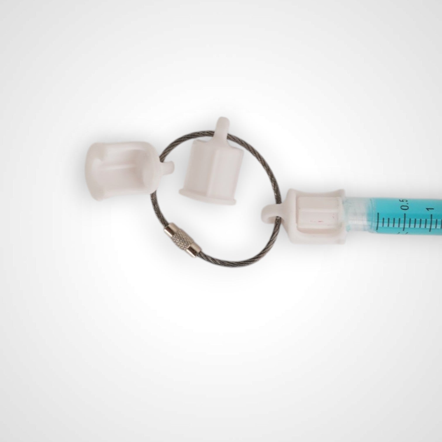 Three white polylactic acid created using additive manufacturing faux flush cap clip on steel cable keyring. Featured attached to a syringe. Shown on a white background.