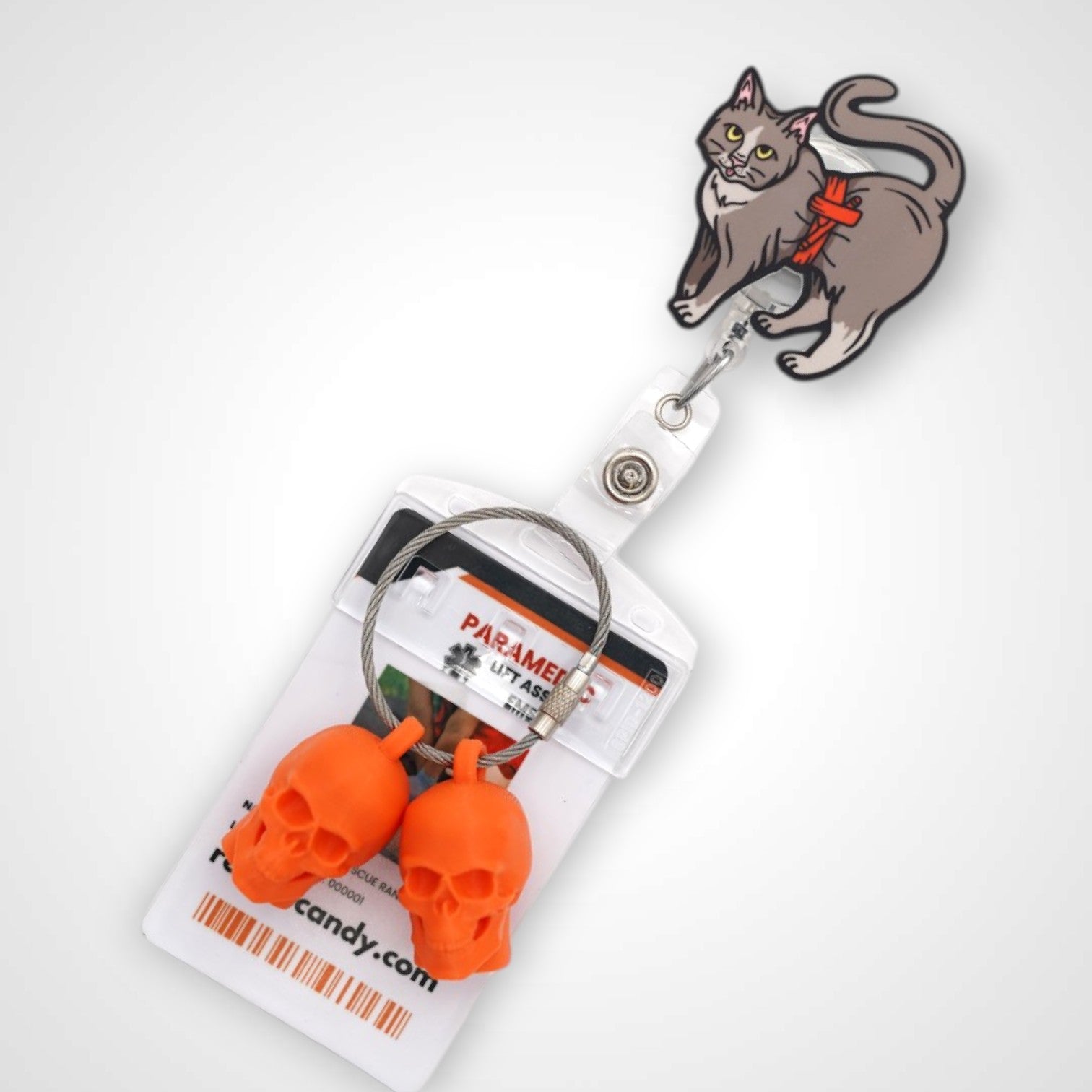 Tournicat badge reel. On a swivel-alligator clip that rotates 360° with a nylon retractable string. Shown on a white background.