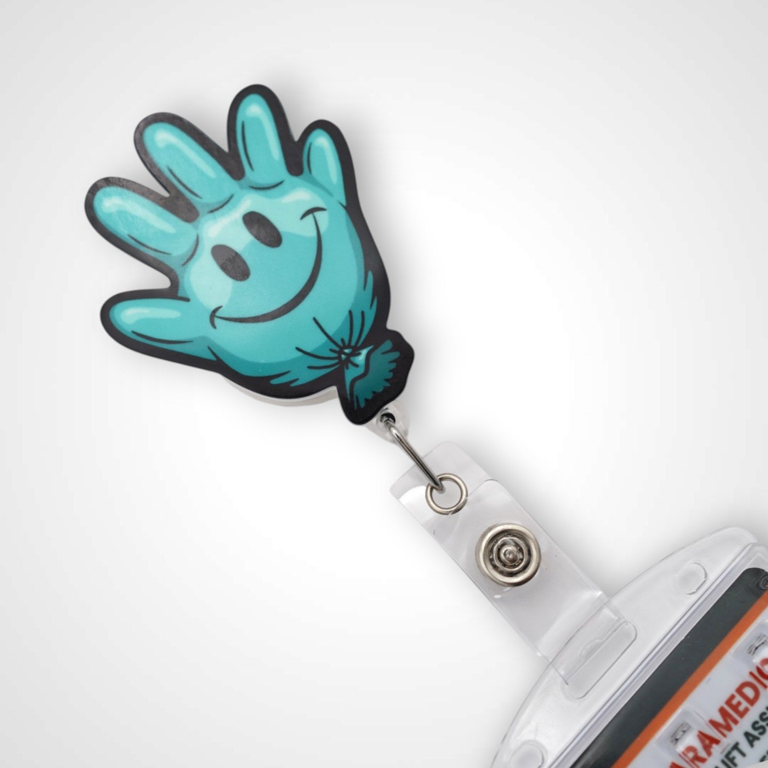 Teal Happy Glove badge reel. On a swivel-alligator clip that rotates 360° with a nylon retractable string. Shown on a white background.