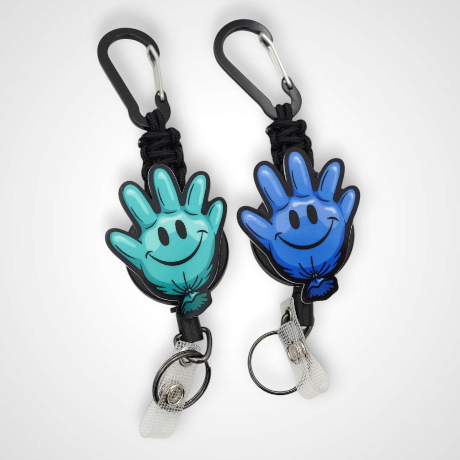 Teal and blue happy glove partner set badge reel. On a carabiner with a steel retractable cable. Shown on a white background.