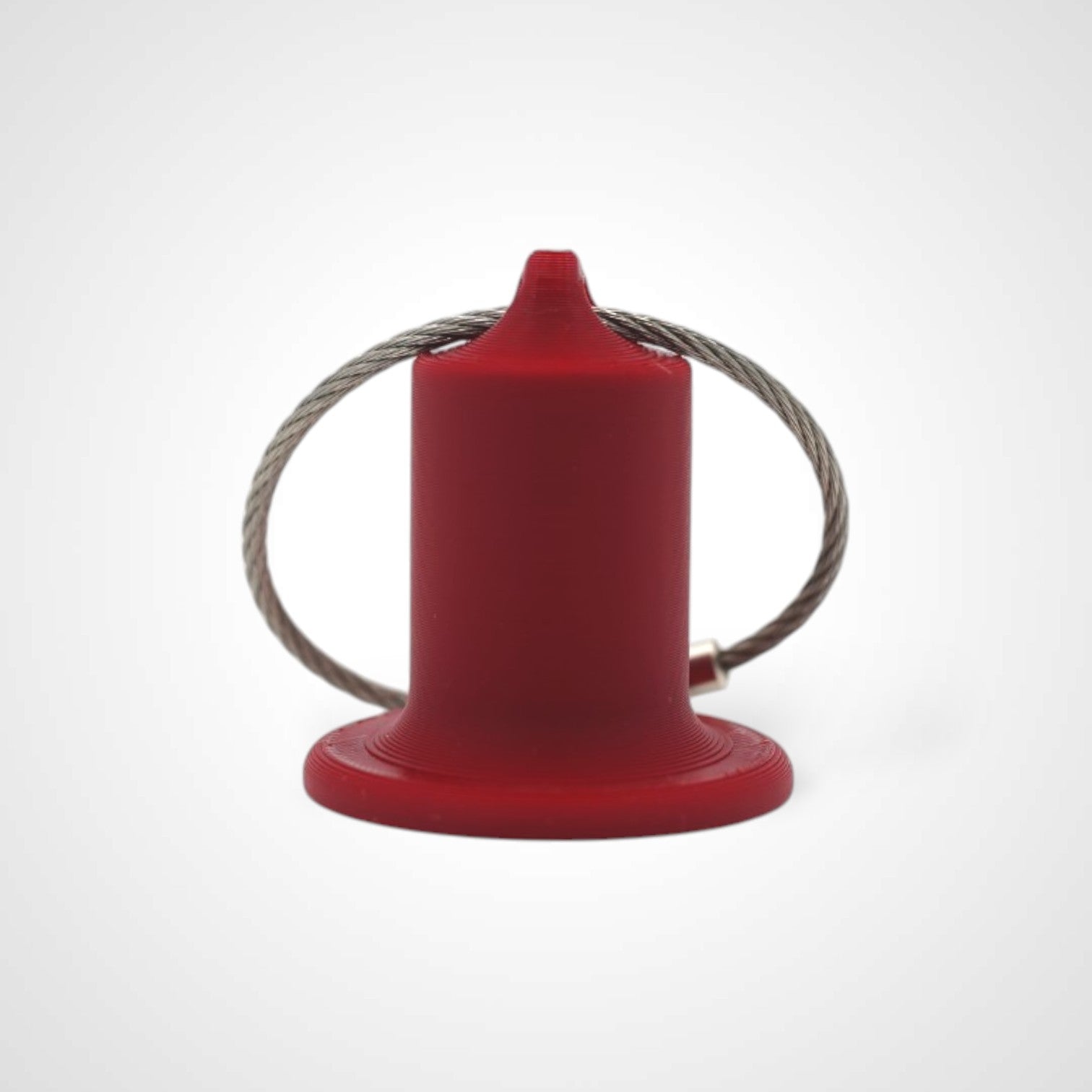 Red 1-inch roll holder made with polylactic acid, created using additive manufacturing for holding tape and bandage rolls. With a steel cable keyring. Shown on white background.