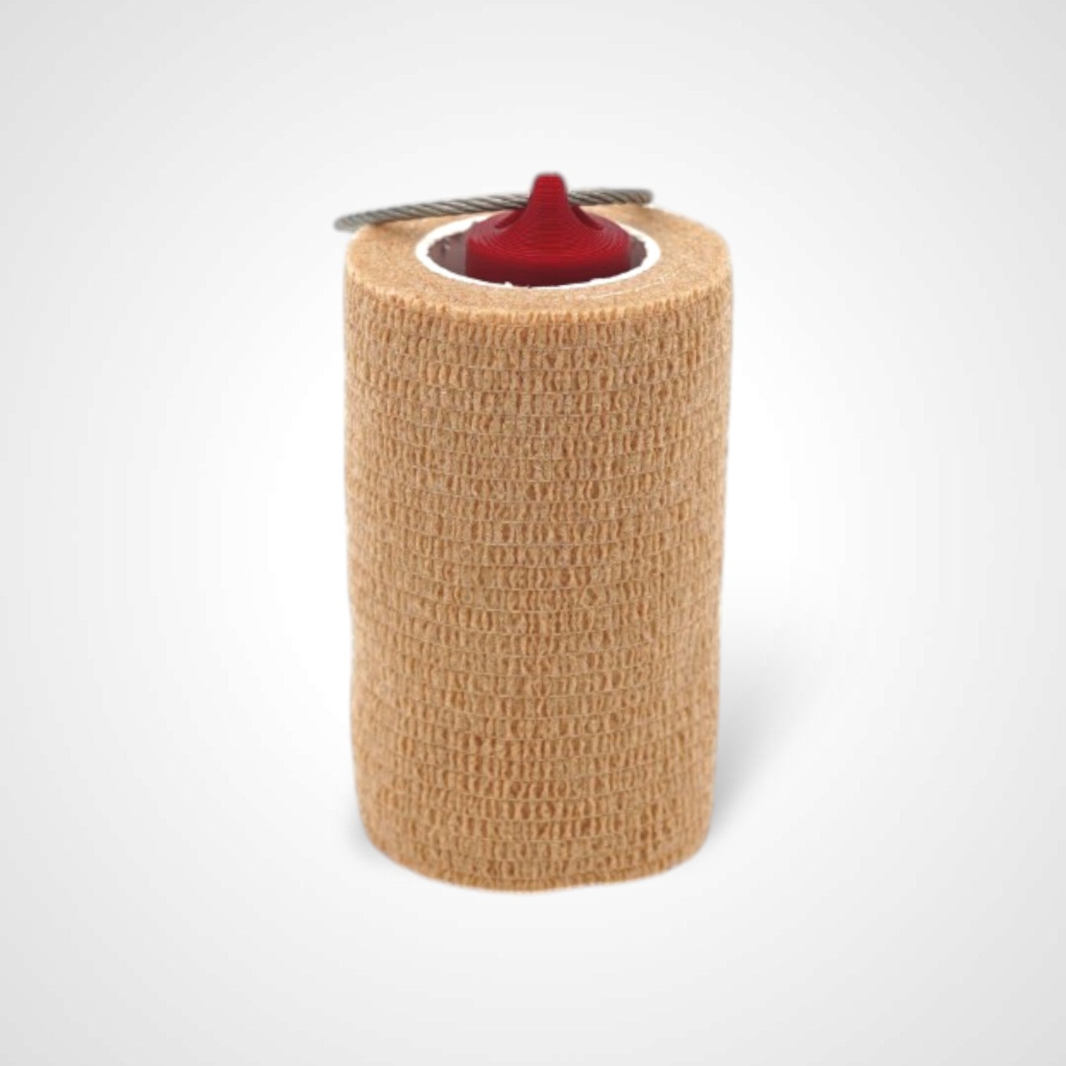 Red 3-inch roll holder made with polylactic acid, created using additive manufacturing for holding tape and bandage rolls. With a steel cable keyring. Shown with tape on white background.