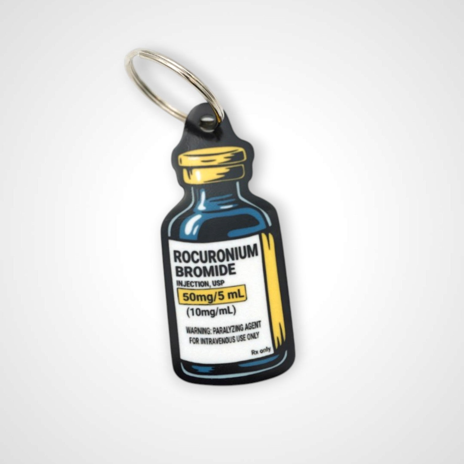 Rocuronium vial cast acrylic keychain with double coil keyring. Shown on white background.