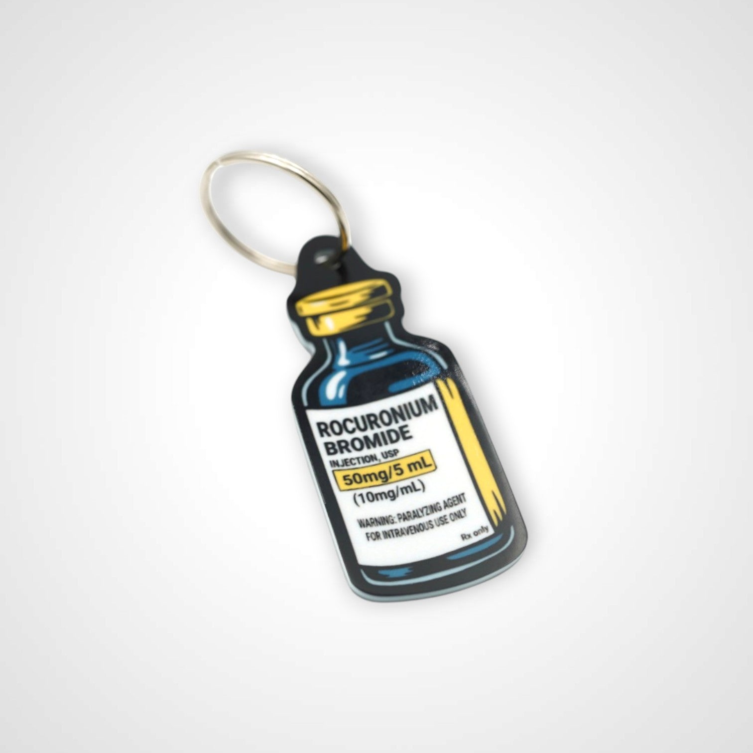 Rocuronium vial cast acrylic keychain with double coil keyring. Shown on white background.