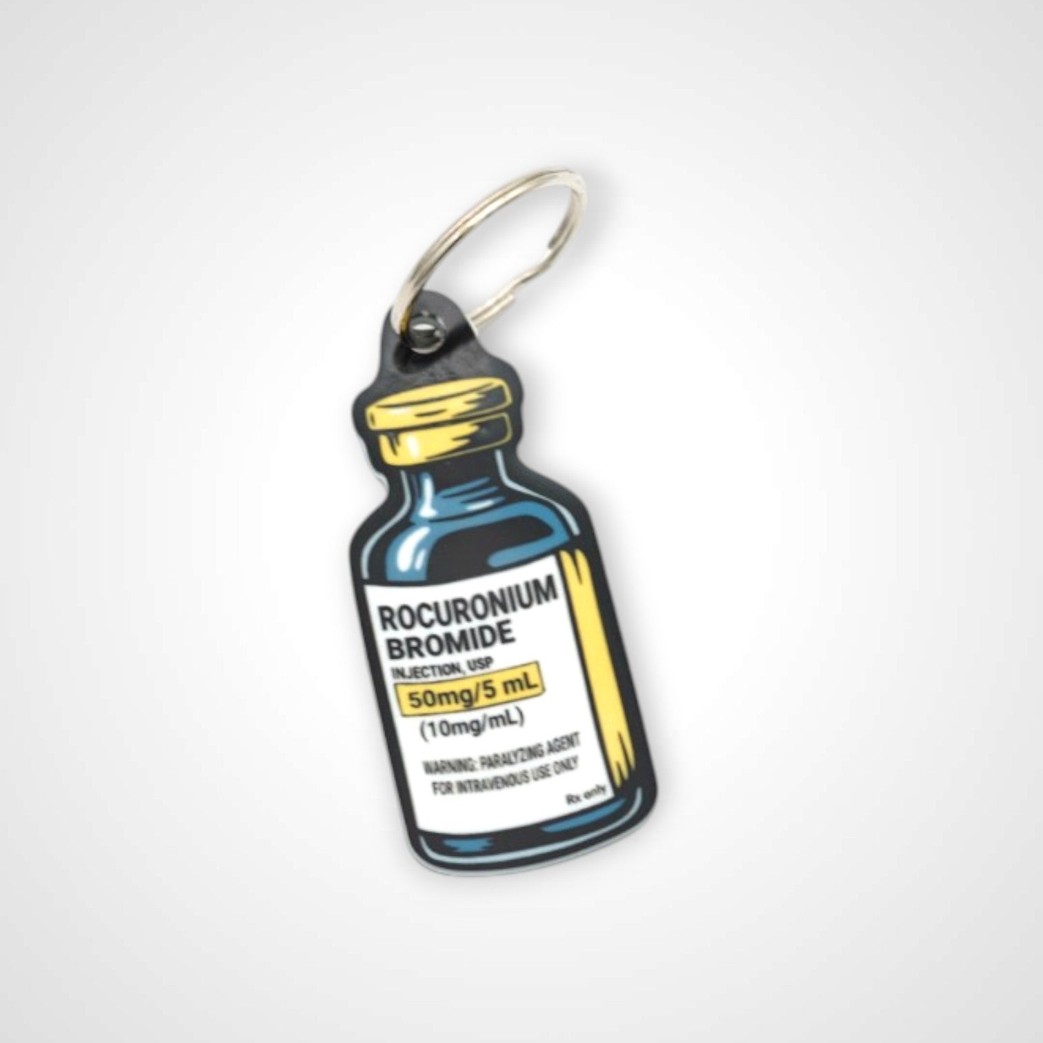 Rocuronium vial cast acrylic keychain with double coil keyring. Shown on white background.