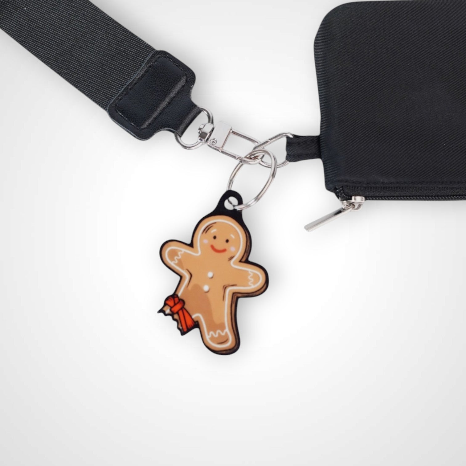 Tourniquet gingerbread man cast acrylic keychain with double coil keyring. Shown on wallet.