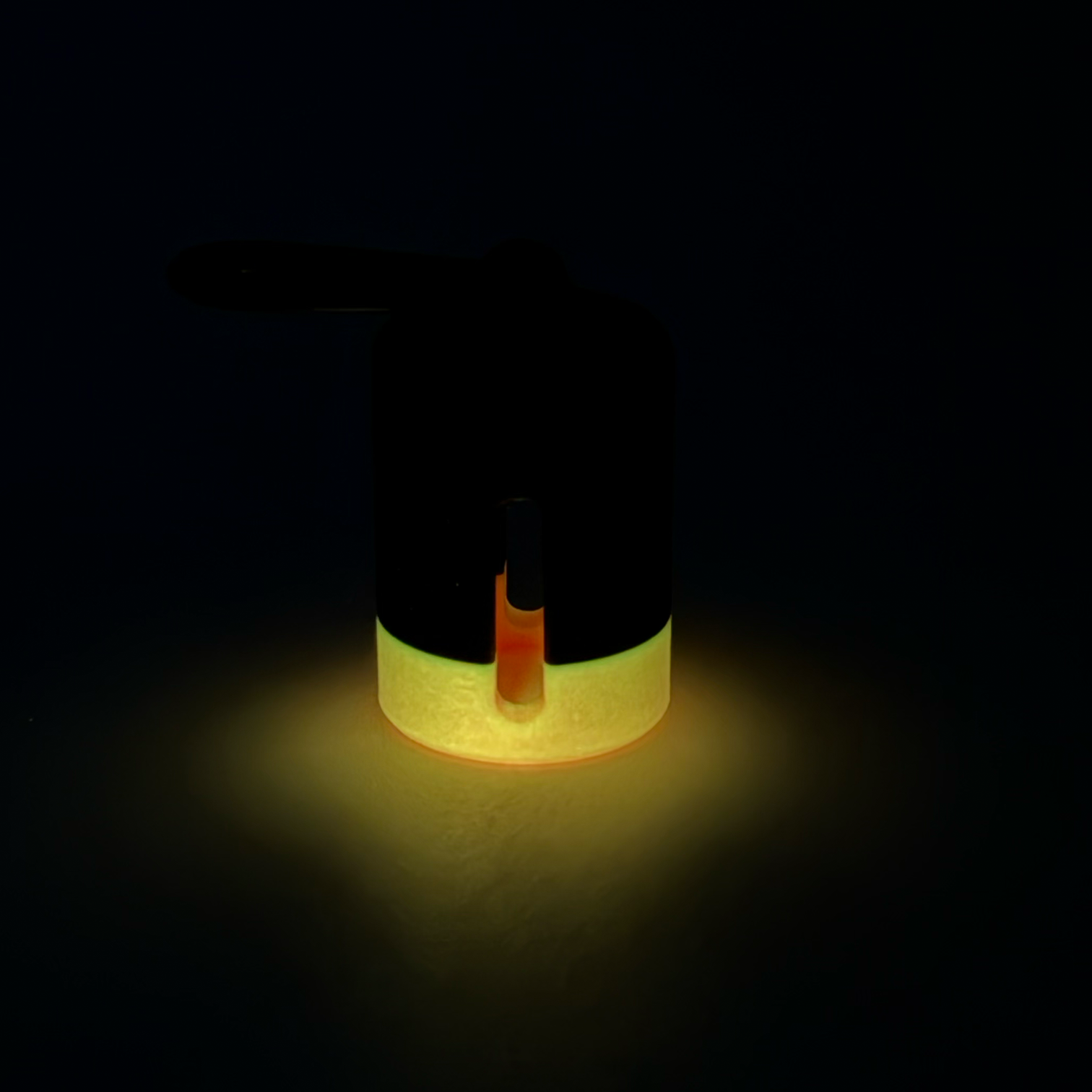 Black with pink stripe vial vault. For empty 2ml or smaller vials, made with polylactic acid created using additive manufacturing. With 1.37" stainless steel black coated carabiner. Shown glowing on black background.