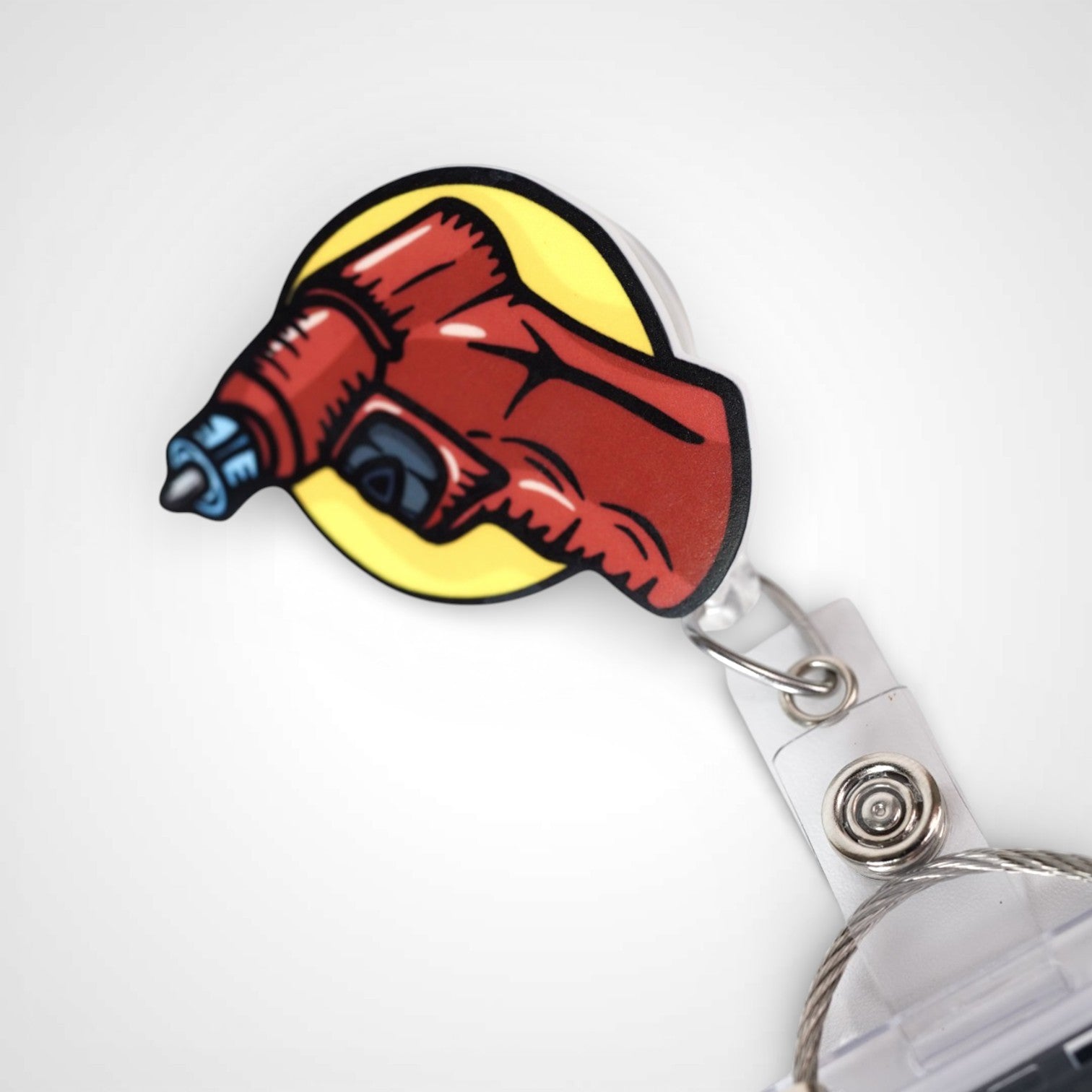 IO Drill badge reel. On a swivel-alligator clip that rotates 360° with a nylon retractable string. Shown on a white background.