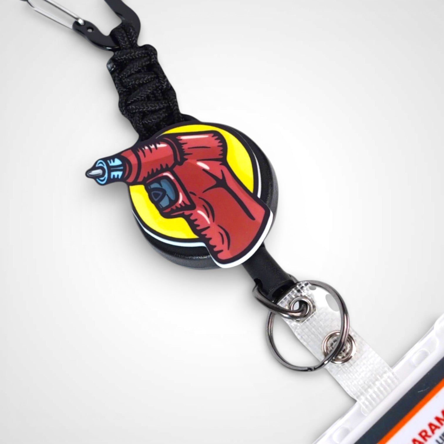 IO Drill badge reel. On a carabiner with a steel retractable cable. Shown on a white background.