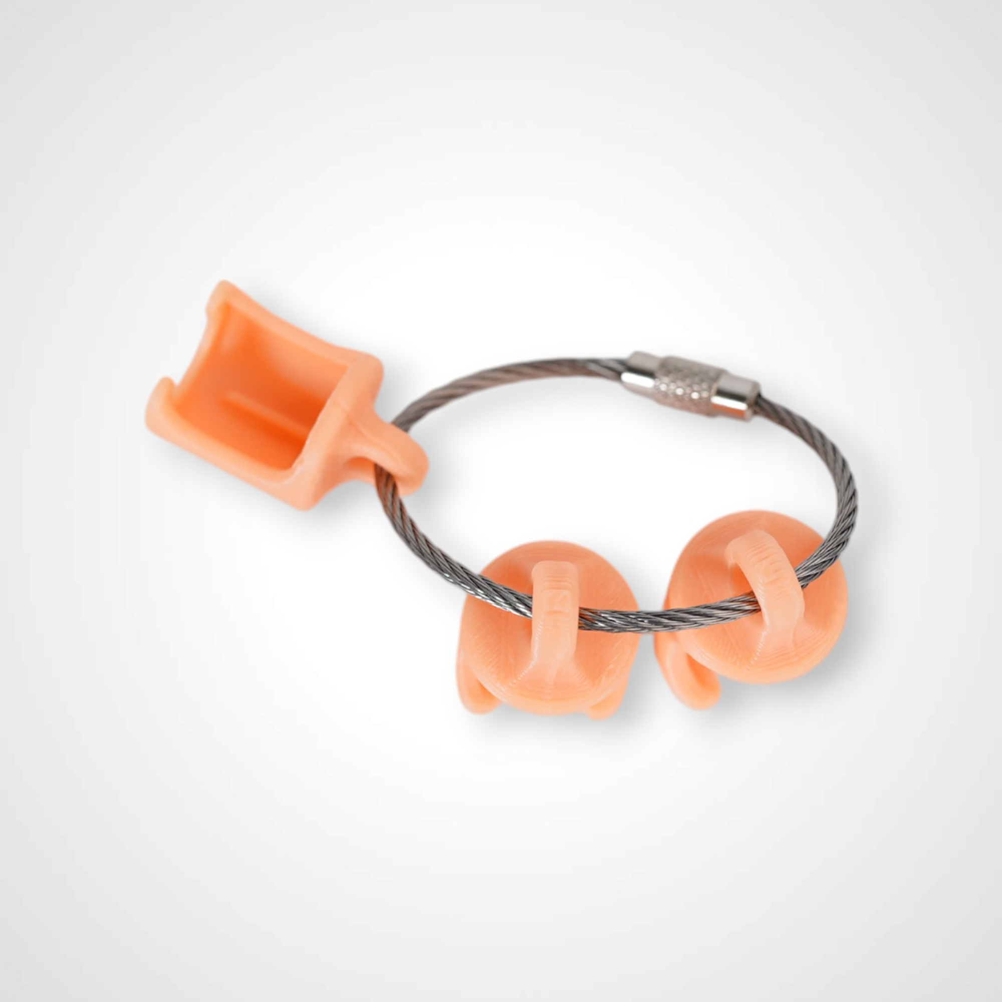 Three orange polylactic acid created using additive manufacturing classic cap clips on steel cable keyring. Shown on a white background.