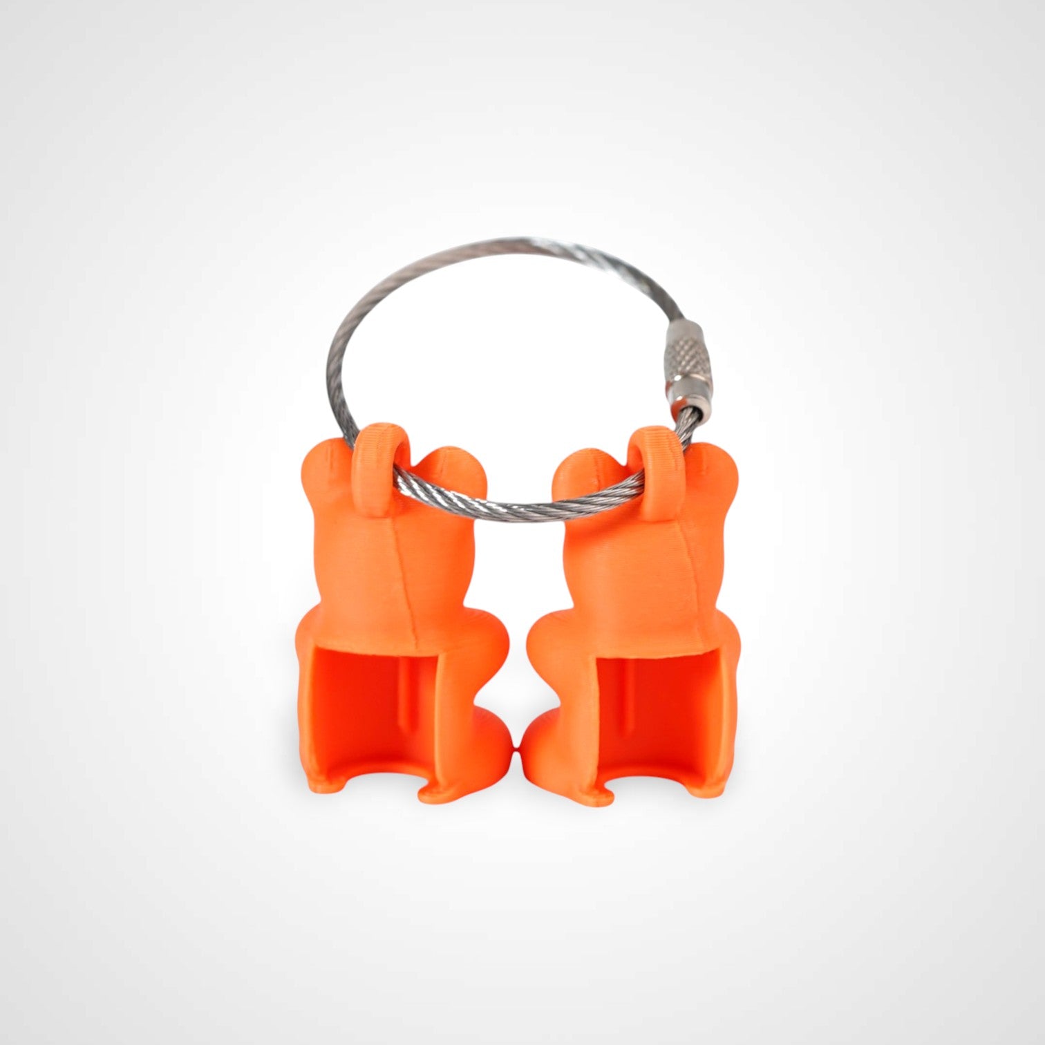 Two orange polylactic acid created using additive manufacturing gummy bear cap clips on steel cable keyring. Shown on a white background.