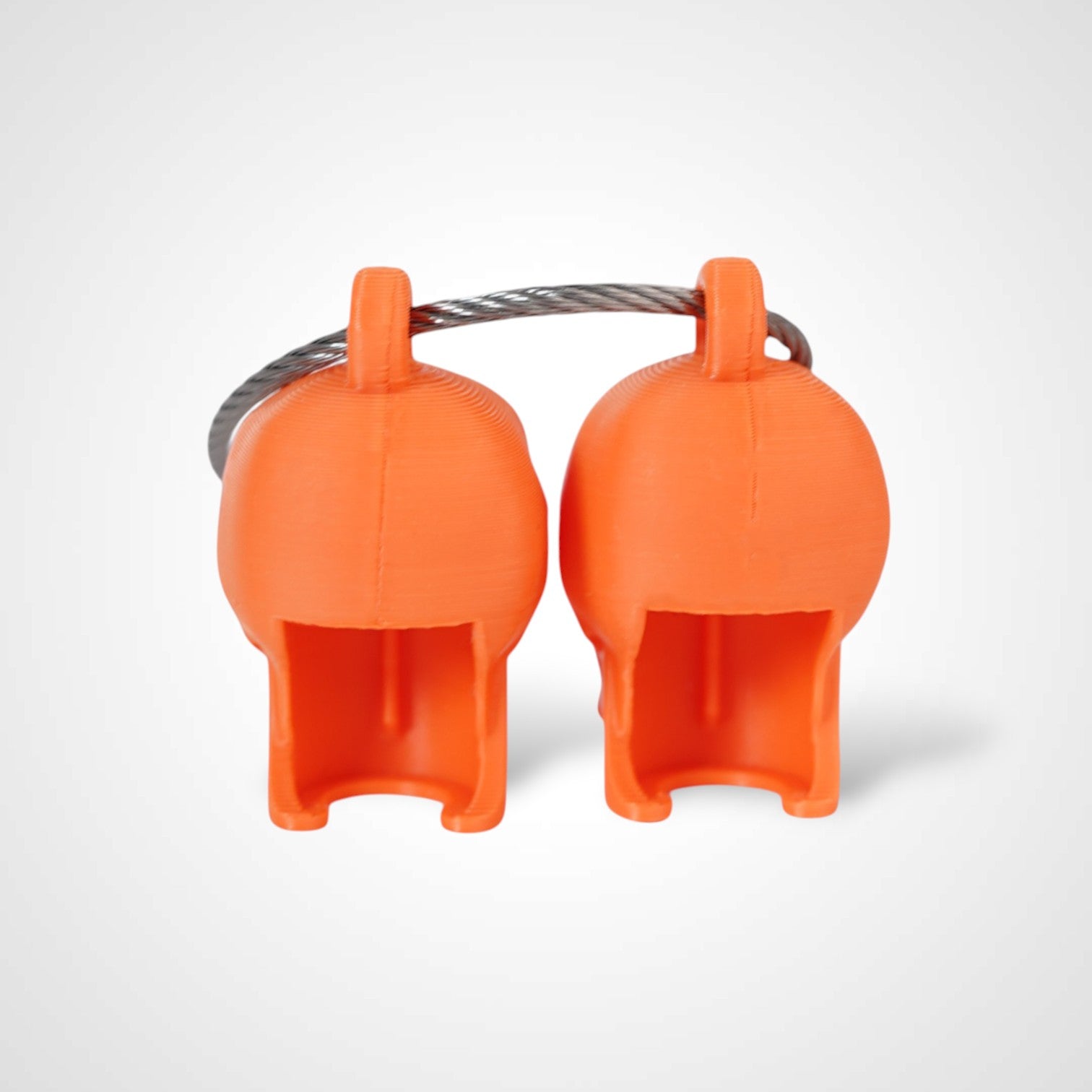Two orange polylactic acid created using additive manufacturing skull cap clips on steel cable keyring. Shown on a white background.