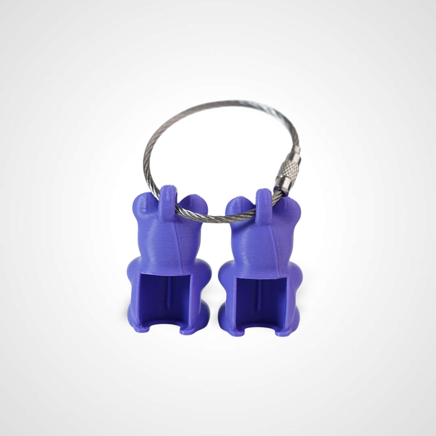 Two purple polylactic acid created using additive manufacturing gummy bear clips on steel cable keyring. Shown on a white background.