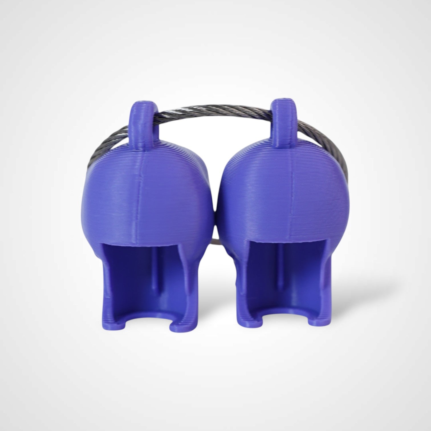 Two purple polylactic acid created using additive manufacturing skull cap clips on steel cable keyring. Shown on a white background.