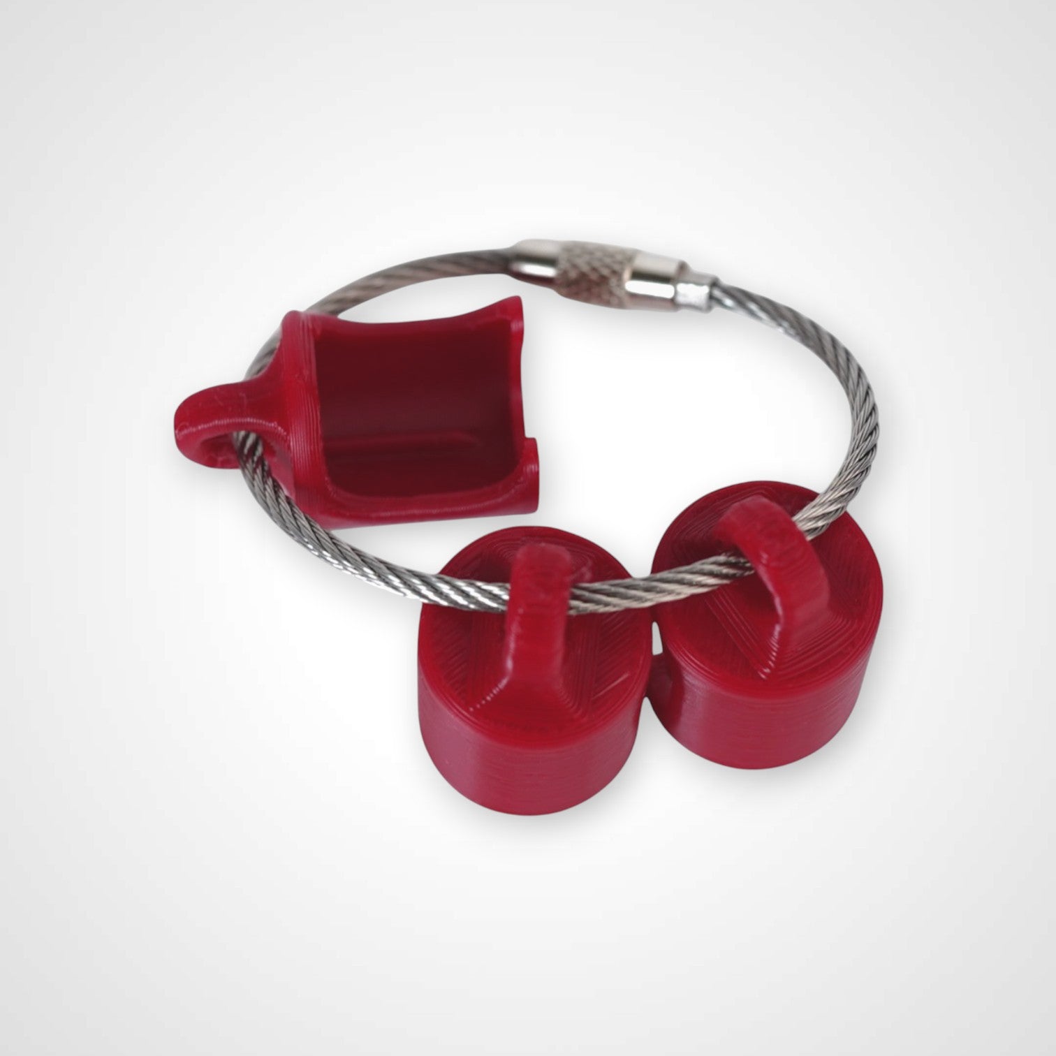 Three red polylactic acid created using additive manufacturing classic cap clip on steel cable keyring. Shown on white background.