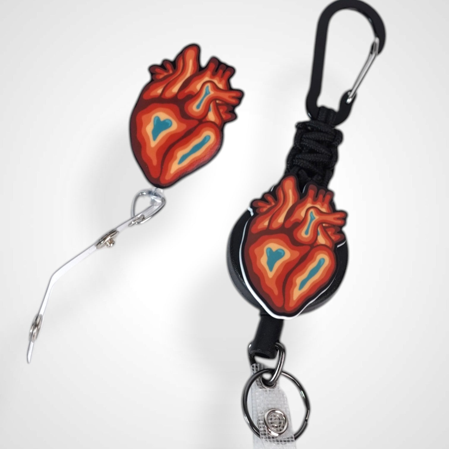 Trippy heart badge reel. On a carabiner with a steel retractable cable next to a swivel-alligator clip that rotates 360° with a nylon retractable string. Shown on a white background.