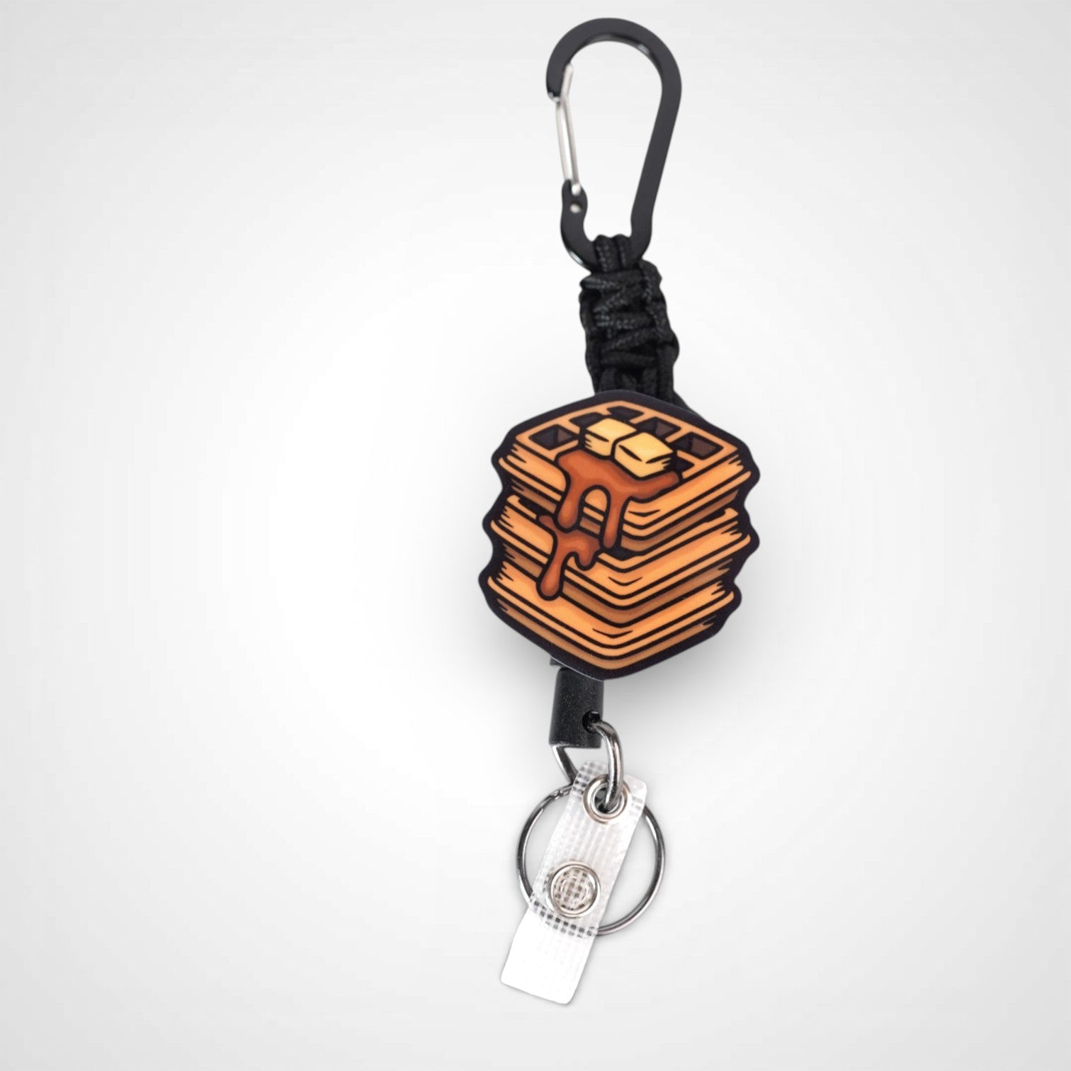 Waffle badge reel. On a carabiner with a steel retractable cable. Shown on a white background.
