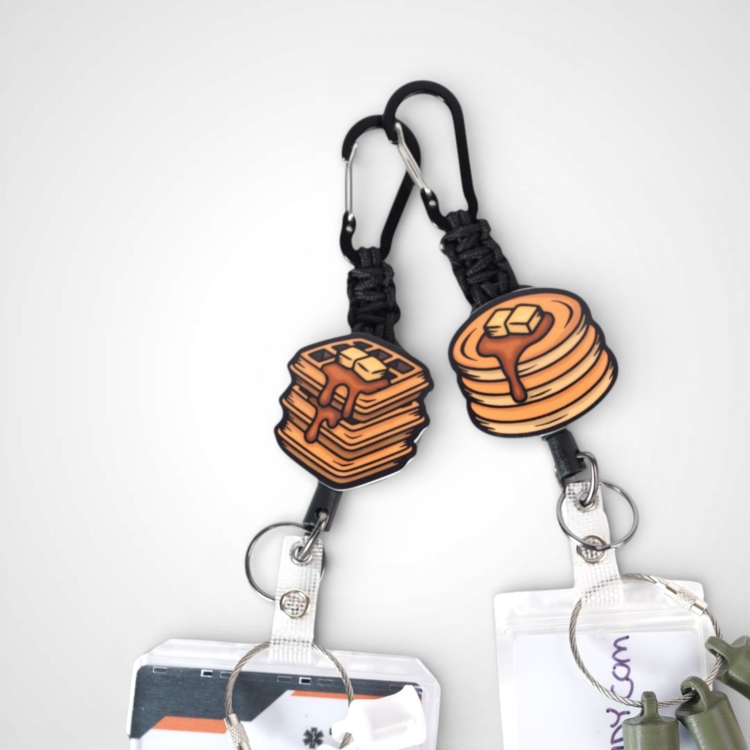 Waffle and Pancake badge reel. On a carabiner with a steel retractable cable. Shown on a white background.