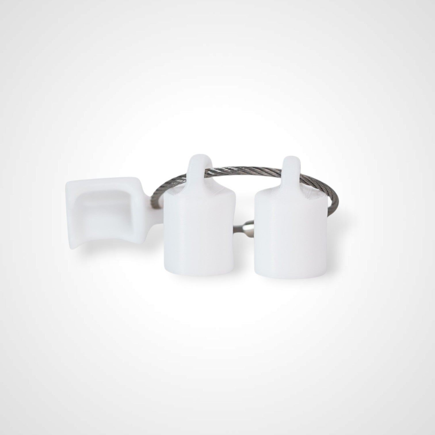 Three white polylactic acid created using additive manufacturing classic cap clips on steel cable keyring. Shown on a white background.
