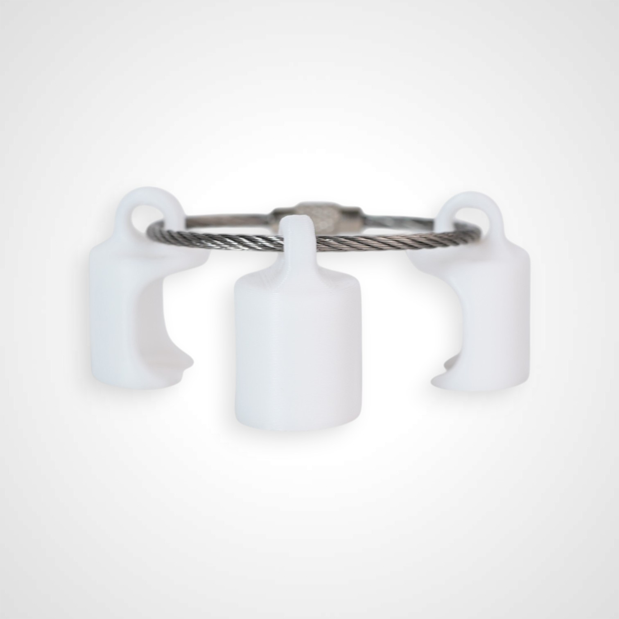 Three white polylactic acid created using additive manufacturing classic cap clips on steel cable keyring. Shown on a white background.