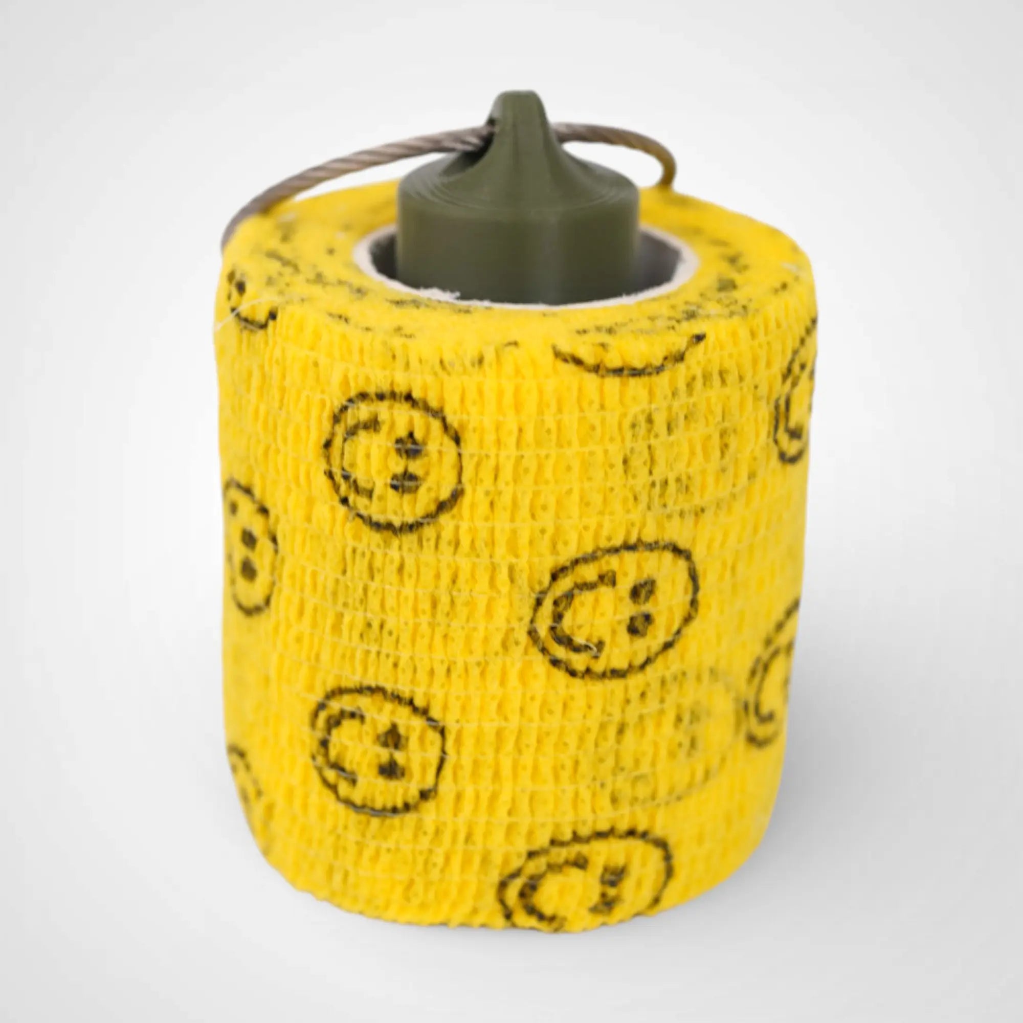 Army Green 2-inch roll holder made with polylactic acid, created using additive manufacturing for holding tape and bandage rolls. With a steel cable keyring. Shown with tape on white background.