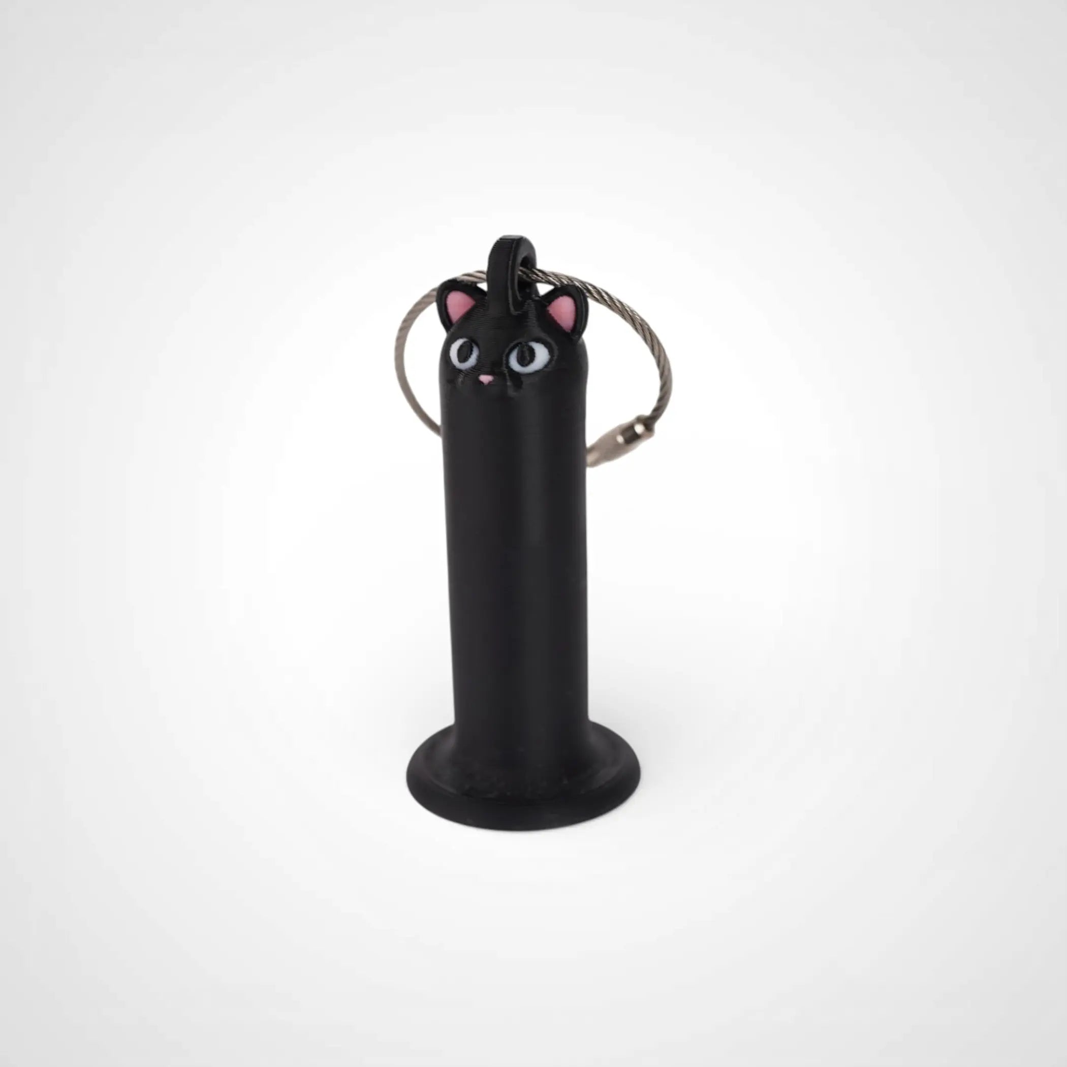 Cat Black 2-inch roll holder made with polylactic acid, created using additive manufacturing for holding tape and bandage rolls. With a steel cable keyring. Shown on white background.