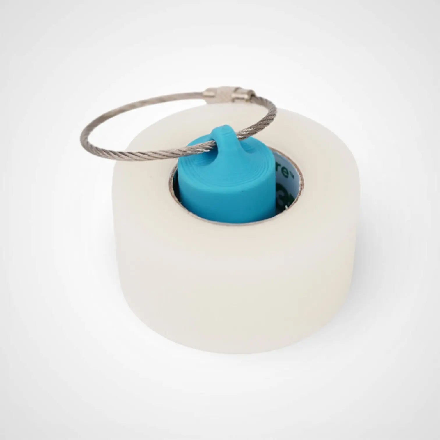 a compact utility keychain called a blue roll holder 1 inch tall to hold and tape transpore tape cohesive bandage coban and bangade rolls for EMS, paramedics, EMT's, nurses, flightmed, vetmed, and athletic trainers